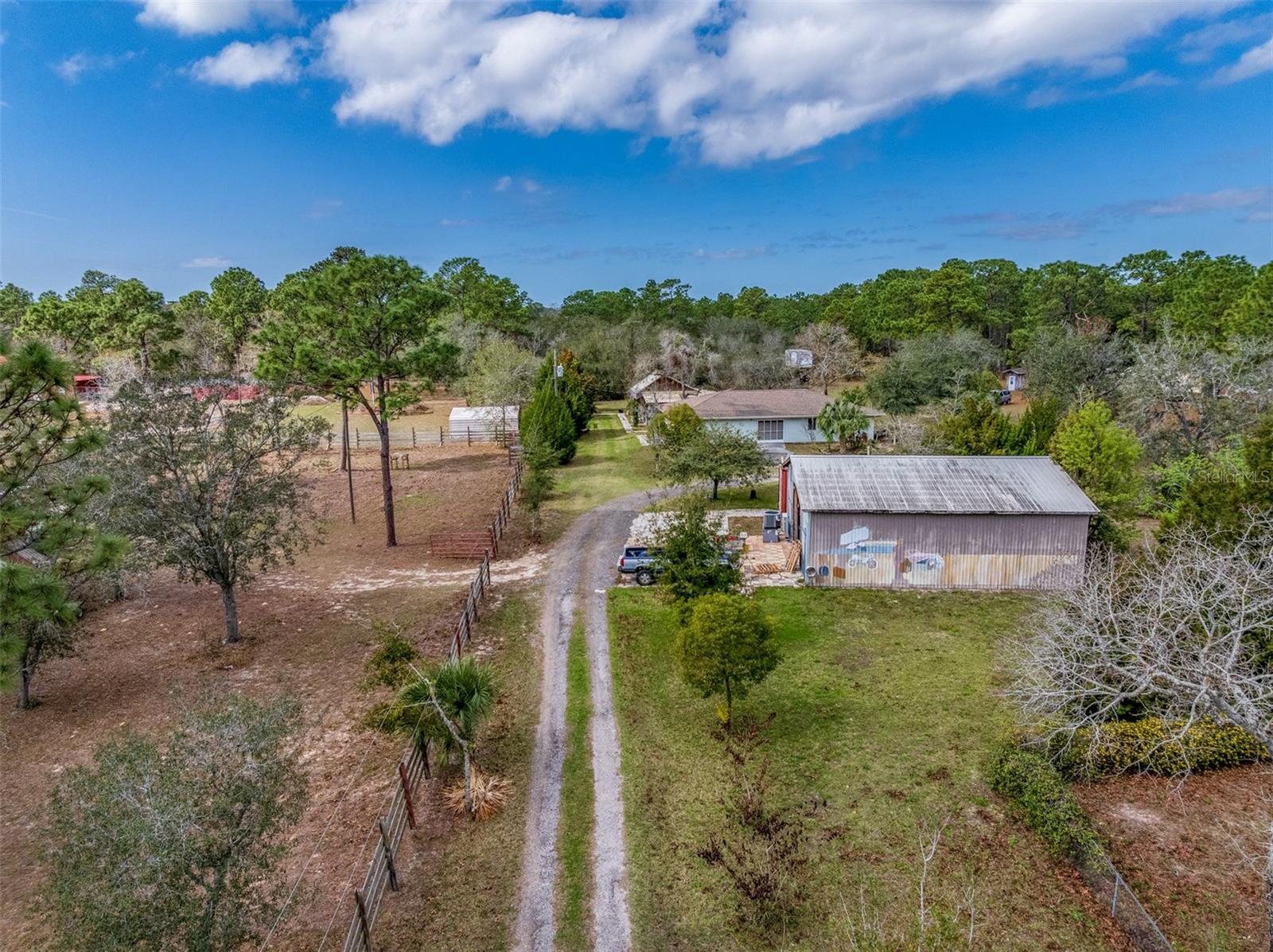 21-acre multi-use property with existing residences and extensive frontage on Sunshine Grove Road. Featuring 1,322 feet of road frontage, seven access points from three roads, and high daily traffic counts, this property offers exceptional visibility and flexibility. Multiple dwellings are currently on-site, providing immediate use or potential income. Existing infrastructure includes five power poles, three wells, and four septic systems. Additional improvements include a 1,680 sq ft heated garage with bathroom and two large pole barns. Convenient access to Highway 50 and the Suncoast Parkway allows easy travel north to Crystal River and south to Tampa. Property is surrounded by schools and established neighborhoods in a rapidly growing area. Zoning and permitted uses to be verified by buyer.