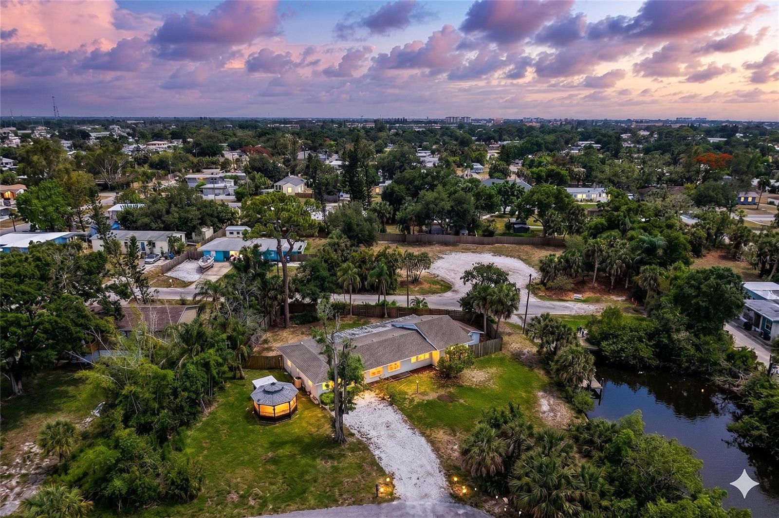 Virtually Staged. SUNSET VIEWS and a great DEAL! **ONE OF A KIND** oversized property directly on the Intracoastal Waterway in Nokomis Florida. No HOA. No CDD. No Limitations. Front of house faces west, offering endless sunsets every night.
Loreto Court (County) Bay Access is located on the adjacent street. Very quiet, well manicured , county access for you and your kayak! This "Old Florida" gem in Nokomis is a rare find, offering a quintessential coastal lifestyle at an absolute STEAL of a price. Situated on a lush 12,000-square-foot lot this property provides the freedom to house your boat, RV, and even chickens, all while being steps away from a County-maintained BOAT RAMP and seawall. The main 3-bedroom, 2-bathroom residence exudes vintage character with old-world look tile and a cottage-style kitchen, complemented by a detached "gazebo-style" GUEST SUITE that is perfect for rental income or a private home office. While the home is a solid candidate for a creative renovation or a spectacular stilted rebuild to maximize those VIEWS OF SHAKETT CREEK & DONA Bay, the heavy lifting has already been done with a newer roof, septic system, and electrical panel (all 2018), plus a raised HVAC and generator hookup for total peace of mind. Whether you're enjoying sunsets, enjoying the massive SCREENED LANAI, or biking the nearby Legacy Trail to Nokomis Beach, this property represents a phenomenal deal for anyone looking to secure a high-potential slice of the Gulf Coast without the waterfront taxes.