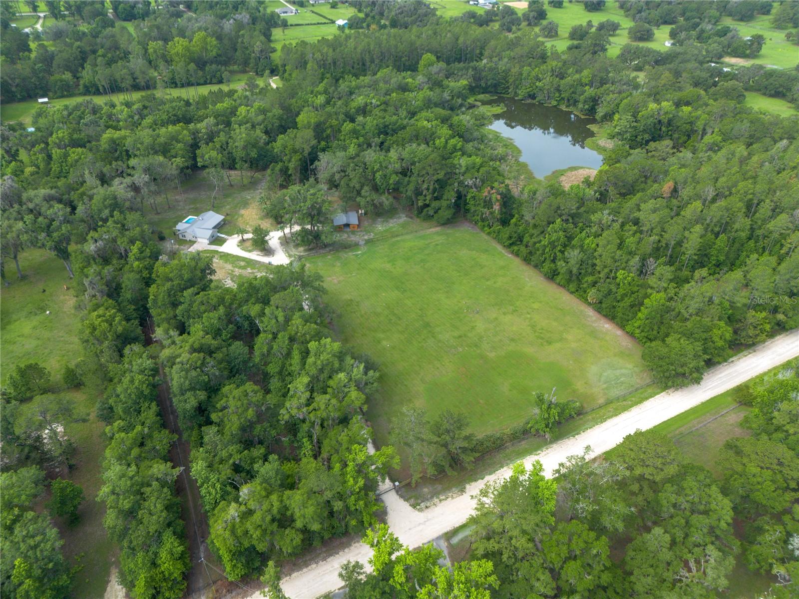 This pristine 12.28-ACRE equestrian estate offers the ultimate private sanctuary for horse and rider. Nestled in the heart of Marion County’s highly coveted Farmland Preservation Area, completely fenced at the end of a peaceful neighborhood and surrounded by elite private horse properties, this residence provides the perfect blend of luxury living with an additional dwelling, equestrian functionality, and unmatched privacy with a new electric Gated Entrance. At this Residence you'll enjoy more horses than neighbors!
The beautiful New Pool & Spa residence offers a Total of 4 bedrooms, 3 bathrooms; 2 Car Garage, an In-Law Suite and 3,346 total square feet. Completely remodeled in 2026, Built in 2000. Upgrades including a brand-new 2026 Metal Roof, custom designer kitchen, luxury pool and spa, elite finishes, A High-Cube Additional Dwelling Unit and a stunning infinity-edge shower with custom tile work. The property has huge granddaddy Oaks, towering Cedar trees, Mature Florida Pines, Meyer lemon trees, A Mature Mulberry Tree and a relaxing waterfront creek that creates a tranquil backyard for you and your horses. Additional amenities include a Separate In-Law Suite Tiny Home with 1-Bd / 1 Ba, heated spa, greenhouse, chicken coop, RV hookups, double gated entrances, all-new pool equipment, and a new spa heater.

Designed for any level equestrian, the property features a brand-new Air-Conditioned Tack Room, 4-Stall barn that can be extended to a 5-Stall barn, dedicated horse carriage bay, grazing paddocks, tack room, storage area, and a hot/cold horse wash rack with its own filters and water heater. An antique horse carriage is included with the sale. The estate is fully positioned among some of Marion County's most renowned equestrian properties, offering great security and a premier horse-country setting.

Conveniently located approximately 20 miles from the World Equestrian Center and 20 Miles from University of Florida, and just minutes from the Ocala Jockey Club, this property offers easy access to world-class equestrian venues, veterinary services, training facilities, and championship competition. Whether you're an equestrian enthusiast, trainer, breeder, or simply seeking a private luxury estate with an In-Law Suite, this property delivers a lifestyle few can match. This pool residence is a complete gem and 100 % Turnkey! Vacant and Easy to show. Call to See!