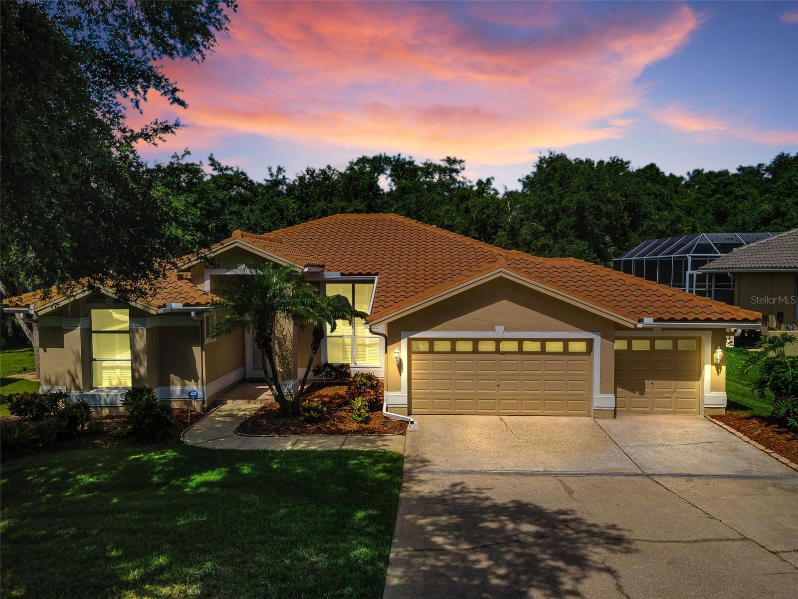 Imagine living in the exclusive The Reserve at Lake Tarpon, a private community of just 52 homes, where you can enjoy luxury living at an exceptional value. Situated on a peaceful conservation lot with no rear neighbors, this spacious 4-bedroom, 3-bath home also includes a dedicated office and an oversized 3-car garage. The thoughtfully designed three-way split floor plan features soaring volume ceilings, abundant natural light, and an open-concept layout that seamlessly connects the kitchen, family room, and outdoor living spaces. A cozy wood-burning fireplace and expansive views of the wooded conservation area create a warm and inviting atmosphere. Architectural details throughout the home include elegant transom windows, arched doorways, tray ceilings, and timeless design elements that enhance its character and appeal. The private primary suite is a true retreat, offering a double tray ceiling, two walk-in closets, sliding glass doors to the lanai, and a spacious en-suite bath with dual vanities, makeup area, soaking tub, separate walk-in shower, and private water closet.
At the heart of the home, the well-appointed kitchen features a small island, cooktop, wall oven, microwave, dishwasher, refrigerator, garbage disposal, and ample storage and work space. The conveniently located indoor laundry room sits between the kitchen and the spacious 3-car garage, which includes attractive epoxy flooring and two garage door openers. A second wing offers two generously sized bedrooms and a full bathroom with a tub/shower combination, while the rear of the home features a private fourth bedroom and third full bath with a walk-in shower and direct access to the expansive entertaining deck overlooking the tranquil conservation area—ideal for guests or multi-generational living. 
Major updates provide value and peace of mind, including a new tile roof (December 2022), new HVAC system (September 2023), water softener (2025), and exterior paint completed less than two years ago. Built with solid block construction, this move-in-ready home presents a rare opportunity to personalize the interior with cosmetic updates while building instant equity. Don't miss your chance to make this exceptional property your own.  High and dry location above the flood plain. *Room sizes are approximate.* Convenient to various golf courses, award-winning beaches, parks with boat launches on the lake, dining, shopping, airports and more.