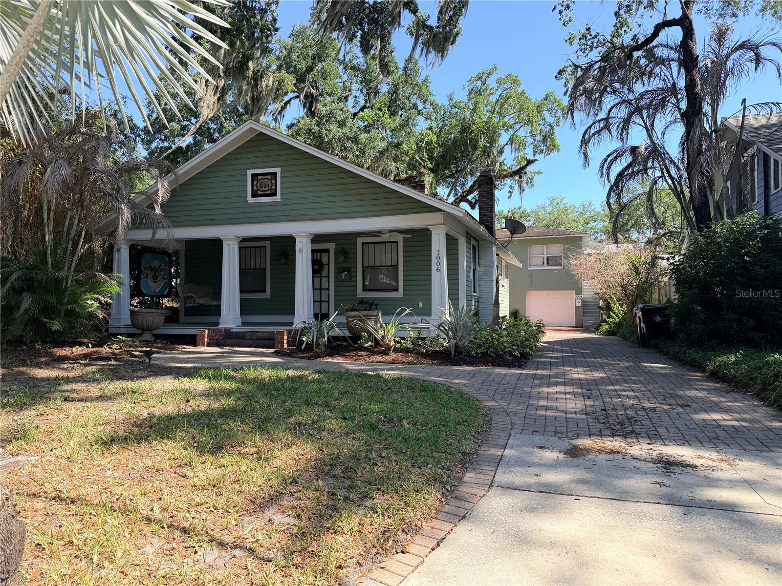 Charming bungalow in the heart of Delaney Park! This adorable home is the perfect starter property with strong investment potential. Relax on the inviting front porch with a classic porch swing, surrounded by beautifully maintained landscaping. The main house features 2 bedrooms, 1.5 bathroom, and a 1-car garage, along with a thoughtfully remodeled full bath. A detached garage includes its own laundry area for added convenience. The property also boasts a spacious garage apartment with a private walk-up entrance, offering 2 bedrooms and 1 bathroom. Recently upgraded with central heating and air, it features granite countertops and its own garage with laundry—ideal for rental income or multi-generational living.