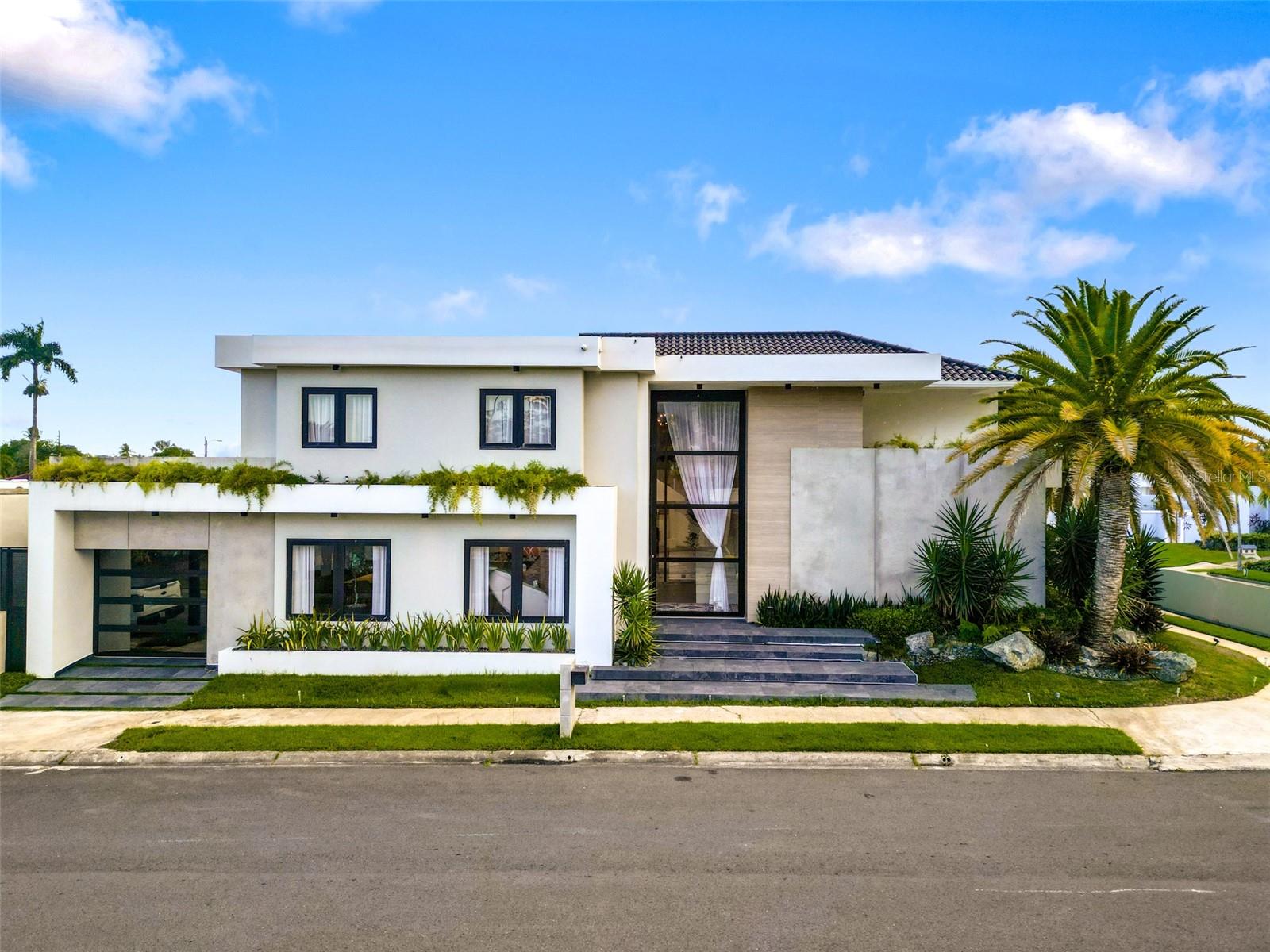 Beautifully remodeled and meticulously maintained, this contemporary residence in Dorado del Mar offers exceptional comfort, style, and functionality. Featuring 5 bedrooms and 5 full bathrooms, the home spans approximately 4,600 sq ft of living area and sits on a 6,803 sq ft lot (632 m²). High ceilings, abundant natural light, and a spacious open layout enhance the home’s modern aesthetic and livable design.

The main level integrates generous living and dining areas with a remodeled kitchen equipped with quality appliances, all of which remain with the property. The home flows seamlessly into an impressive outdoor setting that includes a modern pool, covered terrace, gazebo, and multiple entertainment areas, creating an ideal environment for gatherings and everyday enjoyment.

The residence has been fully renovated with contemporary finishes throughout, including updated bathrooms, lighting, doors, flooring, and air-conditioning units. The property also includes a large carport/marquesina and well-designed exterior landscaping that provides both privacy and curb appeal.

Located within the established and highly desirable Dorado del Mar community, the home offers walkability, golf-cart accessibility, proximity to the beach, and convenient access to restaurants, shopping, schools, and major amenities in Dorado. This is a rare opportunity to acquire a turn-key home in one of the area’s most preferred neighborhoods.