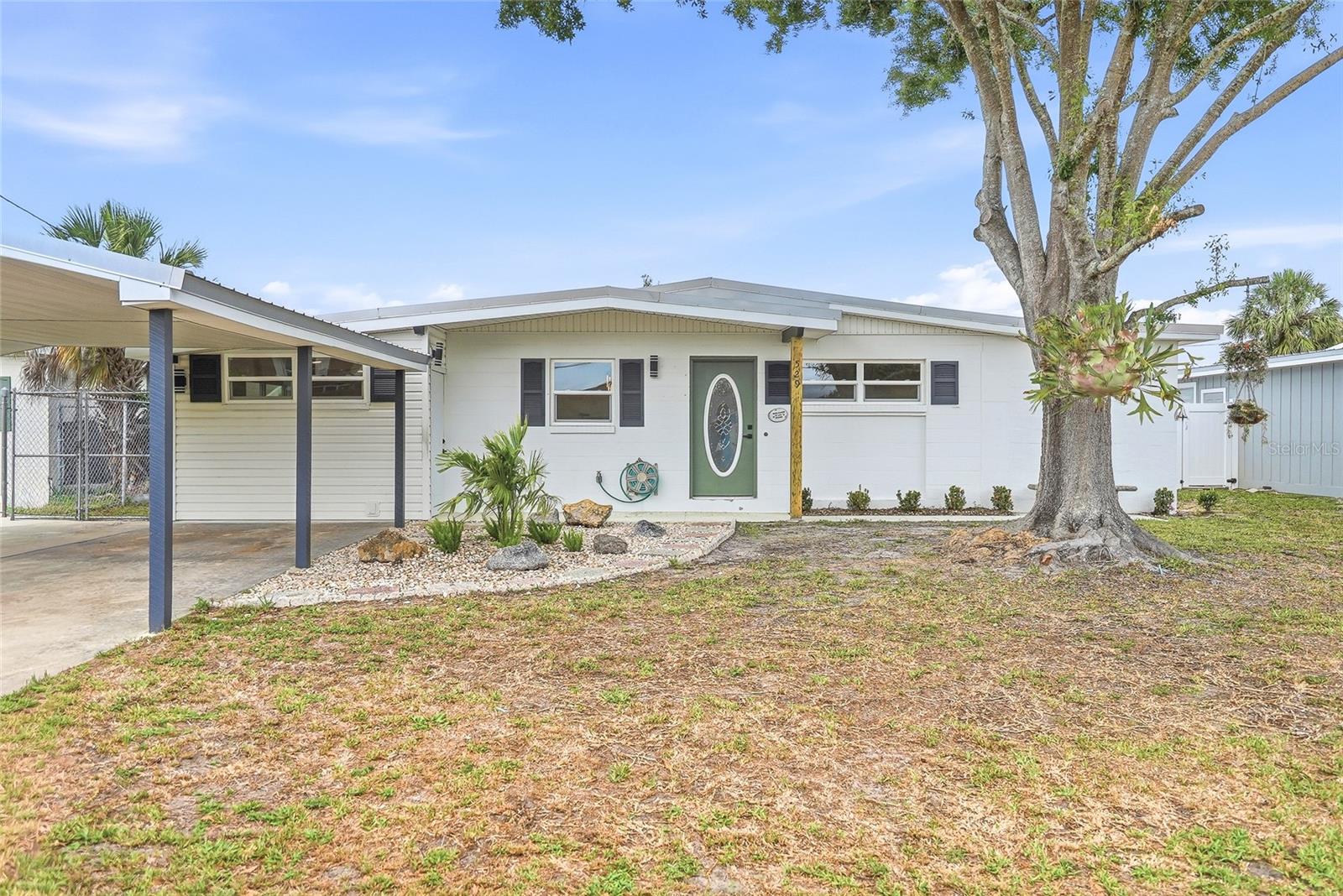Welcome to this beautifully updated 3-bedroom, 2-bathroom block home located in the heart of Apollo Beach, where modern upgrades and everyday comfort come together perfectly. From the moment you arrive, you’ll love the charming curb appeal, covered parking, and inviting feel this home offers. Step inside to an open-concept living space filled with natural light and featuring brand-new vinyl flooring throughout, fresh interior and exterior paint, and a completely renovated kitchen designed to impress. The kitchen serves as the heart of the home with new stainless steel appliances, a touchless faucet, quartz countertops, stylish new cabinetry, ample storage, and a spacious island perfect for gathering, entertaining, and everyday living. Just off the kitchen, an additional flex space provides endless possibilities and can easily function as a formal dining room, home office, playroom, second living area, or whatever best suits your lifestyle. Both bathrooms have been thoughtfully updated with high-end modern finishes, including LED vanity mirrors and smart toilets that add a luxurious contemporary touch. As you make your way outside, you’ll find a dedicated laundry and storage area complete with a 2021 water heater for added convenience and peace of mind. The spacious fully fenced backyard offers endless opportunities to create your dream outdoor oasis, whether you envision a future pool, garden, fire pit area, entertaining space, or room for pets to roam freely. A covered back porch creates the perfect place to relax and enjoy Florida’s beautiful weather year-round, while the storage shed provides additional space for tools, lawn equipment, hobbies, or a workshop setup. Ideally located in desirable Apollo Beach, you’ll enjoy easy access to waterfront dining, local shopping, marinas, parks, and everyday conveniences. Spend weekends exploring the Apollo Beach Nature Preserve, visiting the Manatee Viewing Center, or catching stunning sunsets along the water. With convenient access to Tampa, Brandon, and St. Petersburg, this home offers the perfect balance of coastal charm, modern updates, and everyday convenience.