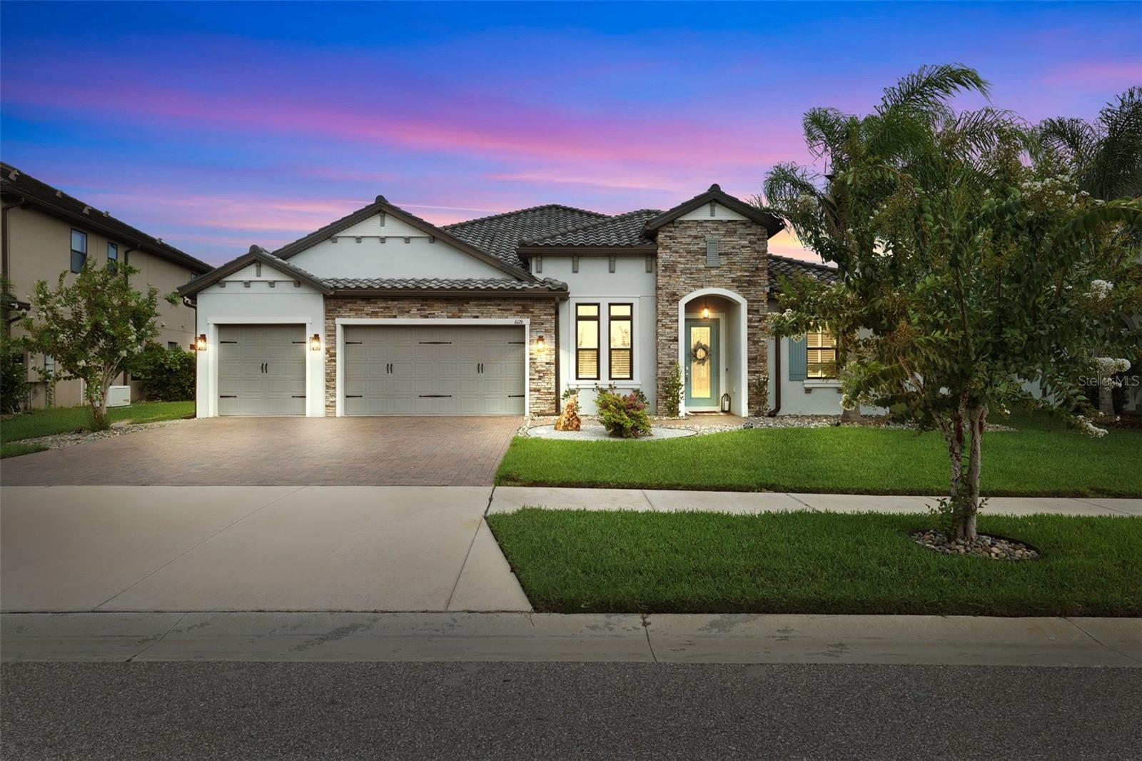 Experience luxury and quality at its finest in this stunning, 3,488 sqft customized estate home featuring a single-story open concept floorplan, 4 spacious bedrooms, 3.5 bathrooms, custom heated saltwater pool and spa, 12ft ceilings, oversized 3-car garage and much more.  Located in the prestigious gated community of Tarramor, the home is perched on a premium .39-acre lot with spectacular sunsets over the lush preserve that neighbors the property.  With no rear neighbors, except for an occasional visit from local deer, the backyard offers privacy you don’t normally find in town.
As you enter the home you are greeted by the quality of custom millwork, beautiful crown molding, designer lighting, wood-grain tile and warm neutral colors.  The impressive gourmet kitchen is the focal point of the living space, perfect for everyday living and entertaining for holidays and special occasions. Outfitted with premium GE appliances, including a double built-in over with microwave, 36-inch gas cooktop, built-in convection oven, and a 42-inch built-in refrigerator, this is a chef’s dream layout.  To top it off, the kitchen also features quartz countertops, a ceramic farm sink, custom-lit cabinetry, an oversized island, spacious pantry storage as well as a Butler’s Pantry complete with a wine refrigerator.  The kitchen opens onto an oversized living room, dinette area and is adjacent to the formal dining room.  Just off of the living room sits the home office with stunning custom shelving with built-in lighting.
The Owner's Suite offers a private retreat with a custom feature wall, elegant bedside chandeliers, coffered ceiling with illuminated crown molding, and two custom-designed walk-in closets. The spa-inspired bathroom showcases dual shower heads, a frameless glass walk-in shower with built-in bench, and a relaxing oversized soaking tub.
The home doesn’t end there.  Situated near the front of the home is a private bedroom and bathroom for visiting guests as well as two additional guest bedrooms on the opposite side of the home from the Owner’s Suite with a shared full bathroom.  Take a few more steps and you will find a bonus room, perfect for a child’s playroom, man-cave, home theater, in-home gym or music room, the options are endless.
If the inside wasn’t gorgeous enough, the rear patio offers ample space for outdoor living and entertaining.  The large heated pool with built-spa is surrounded by pristine pavers and lush greenery.  The yard allows plenty of space for outdoor activities and pets.  Enjoy mornings with visiting deer and evenings with the sunsetting over the wooded preserve.  The fenced yard is complete with maturing and well maintained landscaping and includes a custom built storage shed and outdoor equipment and supplies.
Residents of Tarramor enjoy access to outstanding resort-style amenities, including a community pool, state-of-the-art fitness center, and an elegant clubhouse with a full kitchen available for private gatherings. This gated community offers the added benefits of no CDD fees and no required flood insurance. Conveniently located near top-rated Hillsborough County schools, major airports, championship golf courses, upscale shopping, and fine dining, this extraordinary home offers an unmatched lifestyle in one of the area's most desirable communities.