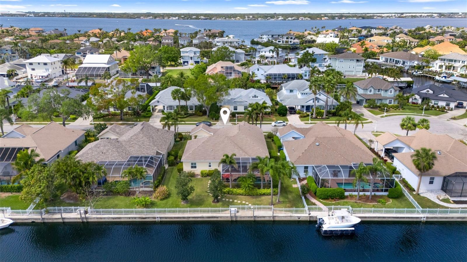 Luxury Waterfront Living at The Inlets at Riverdale. Experience the perfect blend of sophisticated design and waterfront living in this stunning 2,134 sq. ft. custom home, nestled in the highly sought-after community of The Inlets at Riverdale. Every detail of this 3-bedroom, 2.5-bathroom masterpiece has been meticulously crafted to offer the best of Florida’s indoor and outdoor lifestyle. Step inside to find exquisite craftsmanship and modern upgrades, including updated wood plank tile flooring, LED light fixtures, soaring ceilings, and an inviting outdoor fireplace. The fully updated chef’s kitchen is a showstopper, boasting stainless steel appliances, granite countertops, a farmhouse sink, a gas stove, soft-close tailored cabinetry with under-cabinet lighting, and a built-in breakfast bar—perfect for casual dining and entertaining. The spacious primary suite is a private retreat, complete with direct patio access, an updated spa-like en-suite bathroom featuring a freestanding soaking tub, and a walk-in shower. The second bedroom also includes its own en-suite bath, making it an ideal second primary suite. The third bedroom has been thoughtfully converted into a versatile office/guest room with built-in wardrobes but can easily be restored to its original function. Step outside to your screened-in entertainment patio, where a heated pool with relaxing jets awaits. Enjoy breathtaking waterfront views from your backyard canal, which provides direct access to the Manatee River and the Gulf. Boating enthusiasts will love the option to add a floating boat lift with 15 AMP shore power. Located just 6 nautical miles to Tampa Bay, 12 miles to the Sunshine Skyway Bridge, and only 30 minutes by boat to the pristine beaches of Anna Maria Island, this home is a true paradise for water lovers. Designed for peace of mind, this home is equipped with hurricane-grade glass windows and doors, as well as custom Kevlar door covers for added storm protection. The mature landscaping is effortlessly maintained with a public freshwater irrigation system. Located in an exceptional boating community, The Inlets at Riverdale offers a boat ramp, water access, deed restrictions, local fishing spots, a park, playground, and tennis courts. Additional updates include a new AC (2021), new roof (2018), blue light air purifier and new hot water heater. Don’t miss the opportunity to own this exceptional waterfront home—schedule your private tour today and start living the ultimate Florida boating lifestyle!