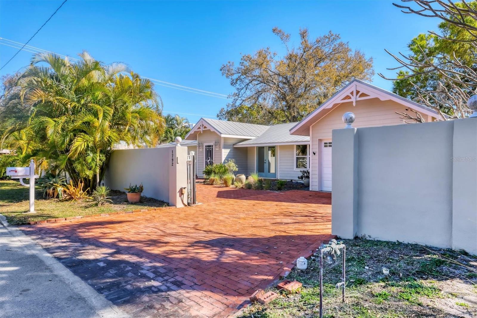 Virtually Staged. Great price for walled-in pool home in PRIME WEST OF TRAIL location, just a few blocks to Southside Village popular shops and restaurants and 1 block to Sarasota Memorial Hospital. The home was remodeled in 1996 and 2000 with vaulted ceilings, newer bathrooms and kitchen, split bedroom floor plan, pool (built in  2003 and Pebbletec resurfacing in 2026), interior laundry room and 1 car garage. Tile or wood floors throughout. Property re-piped in 2024, a/c 2019. Perfect for your residence or an easy investment property with weekly or monthly rentals allowed. Rental estimates range from $6k - 7.5k monthly depending on annual  or weekly rental. Very limited rental availability in the area.
