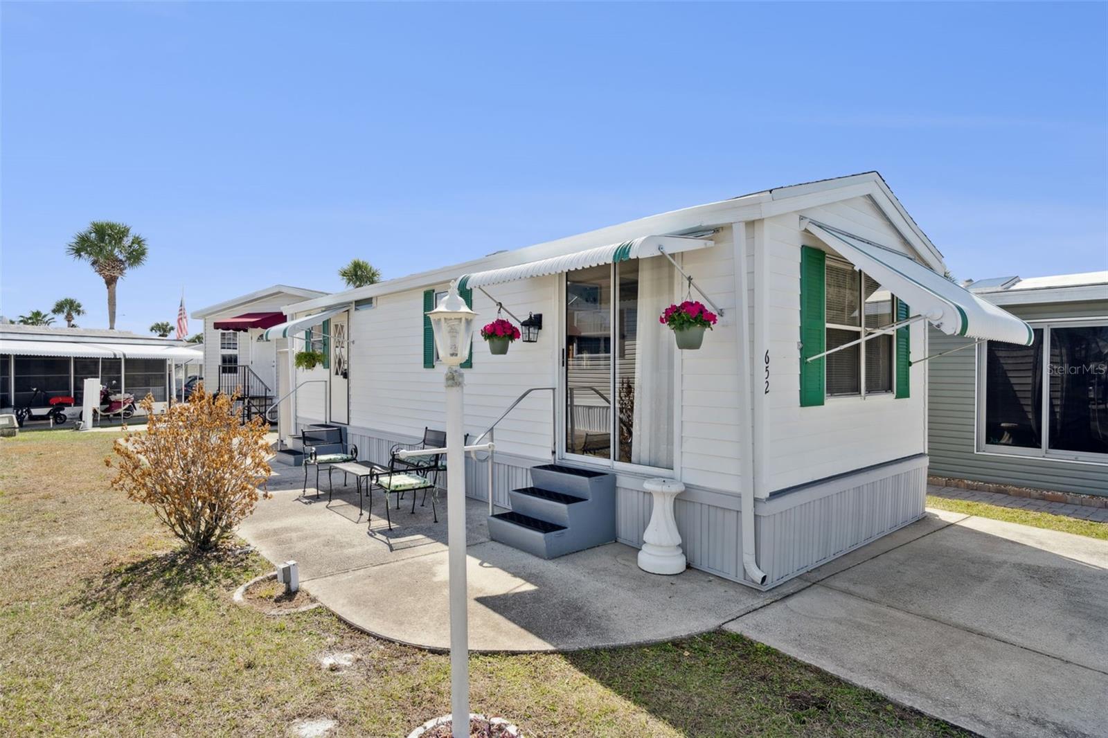 Welcome to Outdoor Resorts — where you don’t just own the home… you own the land.
This well-maintained 1 bedroom, 1 bathroom single-wide is being sold furnished. It’s completely move-in ready and ideal for someone looking for low-maintenance living without sacrificing comfort.
The home has been recently painted inside, newer flooring, a Wi-Fi thermostat, and a 4-year-old A/C. Step inside through the sliding glass door into a bright, open-concept living area that flows effortlessly into the fully equipped kitchen. The layout feels light, functional, and welcoming. You’ll find plenty of storage throughout, a clean and comfortable bathroom with a tub/shower combo and comfort-height commode, and a cozy bedroom. The stackable washer and dryer convey.
Outside, you’ll love the generous parking space and the large side patio added in 2014 — a perfect spot for morning coffee, evening cocktails, or gathering with friends.
And the lifestyle? That’s where this property truly shines. Outdoor Resorts sits directly on Lake Davenport and offers resort-style amenities including a 9-hole par-3 golf course, two swimming pools, eight bath houses, tennis courts, shuffleboard, horseshoes, private dock and boat access, and a very active clubhouse with cards, bingo, dinners, dances, arts & crafts, and morning coffee meetups. Don't forget about the new 9 hole lighted miniature golf course in the community as well!
The quarterly HOA of $768 covers water, sewer, trash, basic cable, and ground maintenance — making this one of the best values around. 55+ community, one pet allowed. You’re also minutes from medical facilities, shopping, restaurants, grocery stores, and an easy drive to the theme parks. Ownership of the land is also a plus!