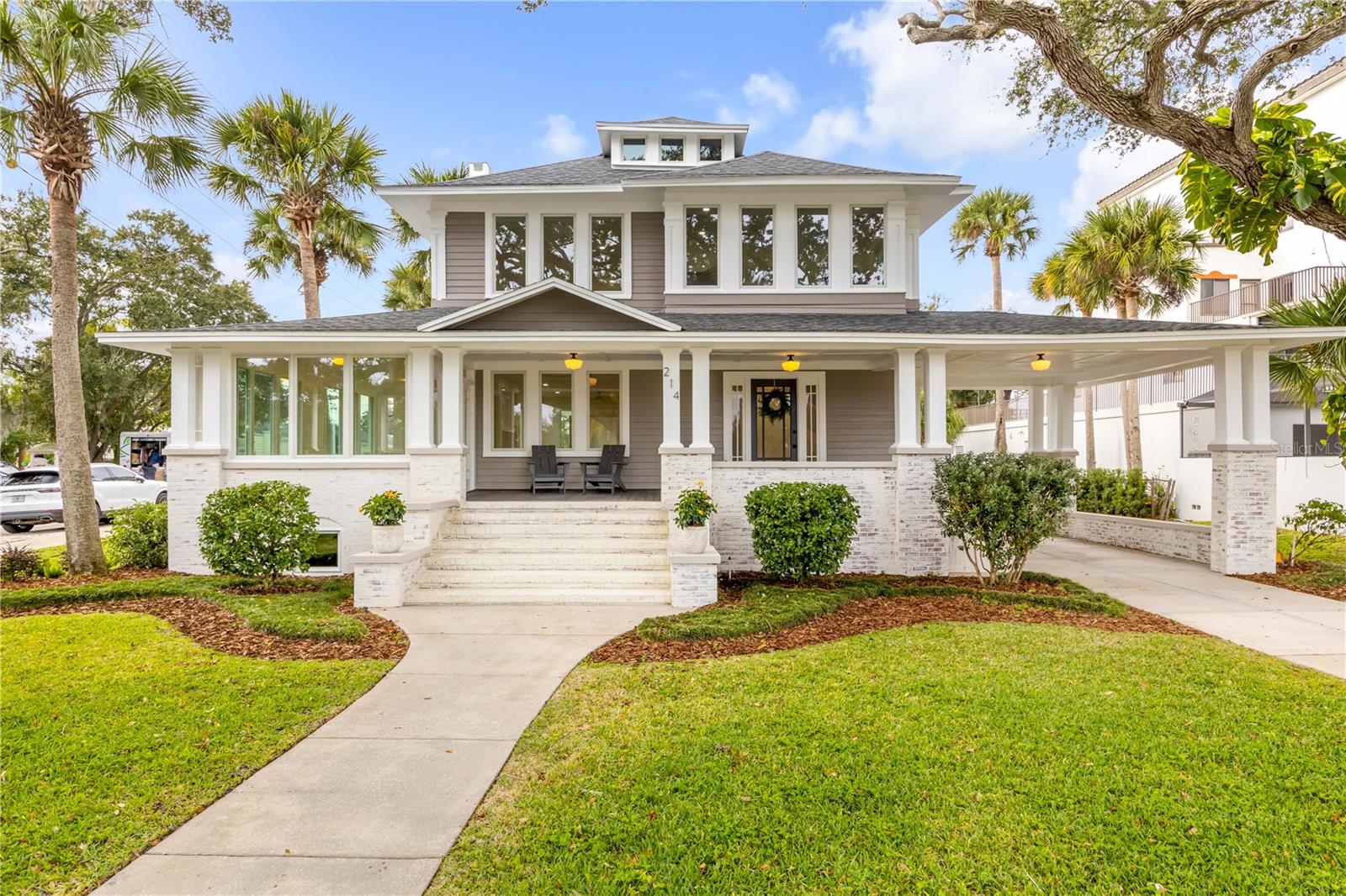 Historic Riverfront Gem – Modern Luxury in the Heart of New Smyrna Beach. 
Step into a piece of New Smyrna Beach history with this beautifully preserved 1958 riverfront home artfully updated for today’s modern lifestyle. Formerly the ACA Harris House, this four-story residence blends timeless craftsmanship with elegant contemporary design.
Original refinished hardwood floors flow throughout this one of a kind four story residence. This home has been completely revitalized from top to bottom. Updates include a yr 2025 roof, HVAC system, plumbing, gas, 200-amp electrical service, impact-rated windows, a modern kitchen featuring premium Bosch appliances w/ a dual energy oven, master suite with bath and so much more. Every detail has been carefully considered — from the luxury-finished bathrooms and lighting to the handcrafted workmanship of the doors and window frames. This thoughtful layout includes a full basement with abundant storage, a spacious main living level with a welcoming sun porch and fireplace, four bedrooms, and a top-floor speakeasy complete with a full bar, wine racks, and cozy seating — perfect for entertaining or relaxing with river views. Additional highlights include a roomy two-car garage, porte-cochere, and yr 2025 concrete driveway. Large covered front porch for enjoying the coastal breeze, a sprinkler system, with room for a pool (drawings available) add even more value.
Nestled in the Mixed-Use District, this property offers incredible flexibility — ideal for a primary residence, Airb&b, (bed & breakfast), or even a personal art gallery this is living space combined for exceptional Urban living. Why not have the best of both worlds? Enjoy tranquil river views, historic oaks, breezes off the Intracoastal waters, and old Florida charm, all within walking distance of Canal Street’s boutique shopping, dining, and vibrant art events.  This rare offering perfectly captures the essence of historic New Smyrna Beach living — where classic architecture meets modern comfort and creative opportunity. This is a wonderful opportunity to own a true riverfront masterpiece in one of the area’s most desirable and dynamic neighborhoods. Come see today...