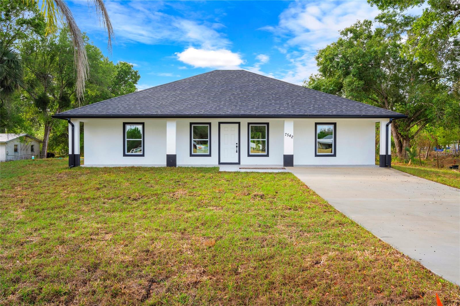 Beautiful brand new 3 bedroom, 2 bath CBS home in Dixie Ranches featuring 10-foot ceilings and a spacious covered front porch perfect for morning coffee and sunset views on 0.36 acres. The kitchen offers tall wood cabinets, quartz countertops, and stainless steel appliances. Interior highlights include tile floors throughout, tiled showers, and sleek black fixtures. Enjoy backyard views from the covered rear porch, with the added bonus of a neighboring lot behind the home that's also available — perfect for extra privacy or future expansion. Combined, both parcels offer the potential to own over 0.7 acres. Impact windows, central A/C, custom closets and doors complete this move-in ready property. Plenty of room for your boat, RV, or toys. Conveniently located near town and shopping. Must see to appreciate. (This is being sold as 0.36 acres, the back lot will be split off but is available for purchase.)