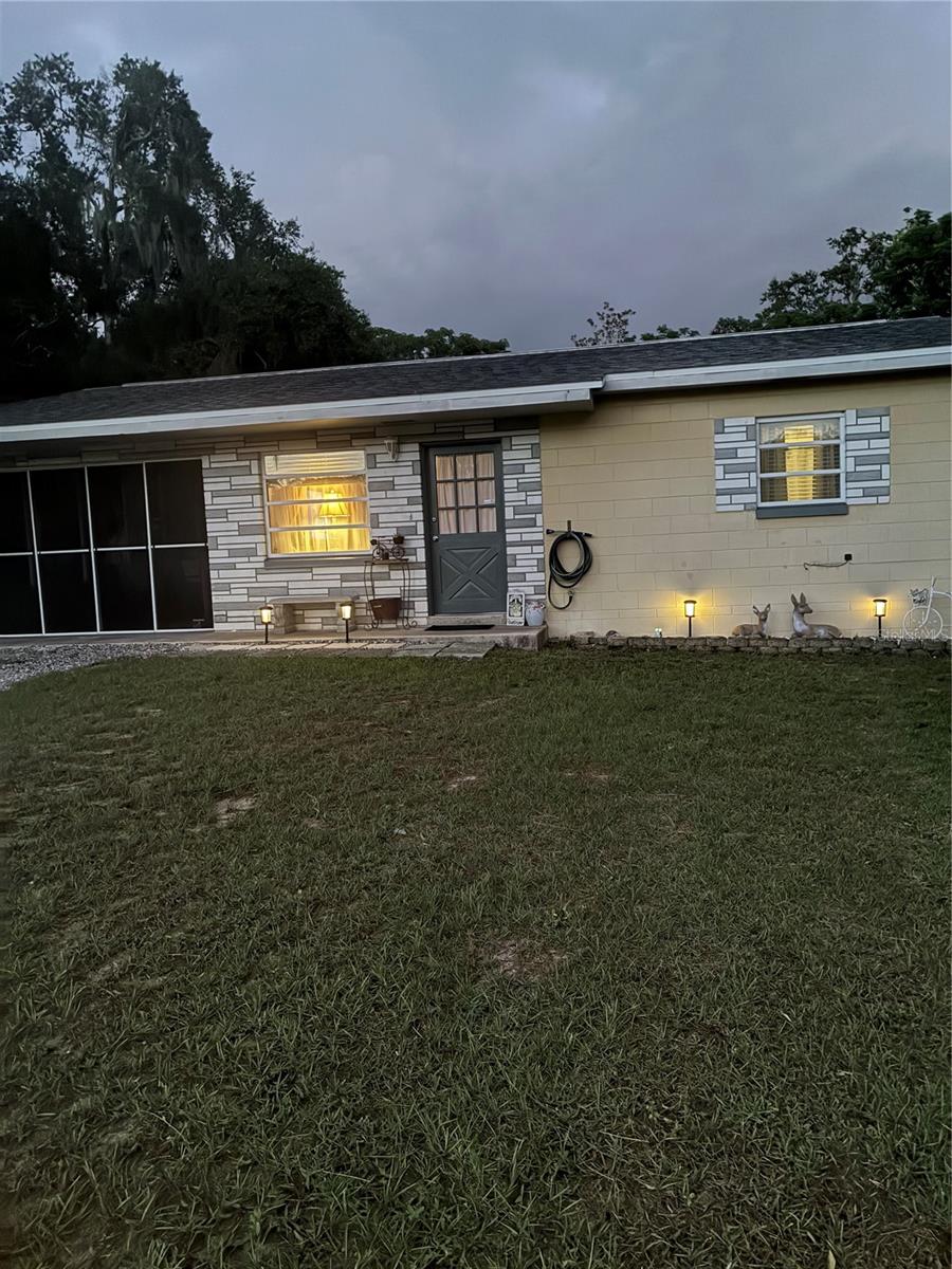 Newly Reduced Price! Don't miss this adorable vintage modern abode. The Remodeled kitchen with island has beautiful granite countertops, The Shaker style cabinetry are a calm gray color. And there is plenty of storage for kitchenware and supplies. Living area is inviting and provides a pleasant space for relaxing or entertaining. Each bedroom boasts two windows, a ceiling fan and a spacious closet. The bathroom has a modern vanity/sink and a retro tiled bath/shower, the best of both. More storage at the end of the hall. Enjoy time on the screened-in back porch with the view of the large backyard. Laundry utility room is convenient at one end of the carport. Plus, all appliances included: microwave, cooktop stove, oven, dishwasher, refrigerator, extra chest freezer, clothes washer & dryer, and ceiling fans. Included also are the window blinds and draperies as pictured. The carport serves well for one car parking. More room for additional cars on the driveway. This home is a few minutes from the Historic Eustis district, a charming place!