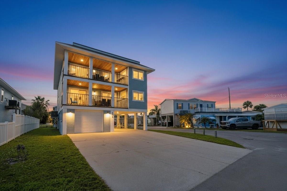Recently remodeled 3-bedroom, 2-bathroom duplex located just a short walk from the beach. This income-producing property has been updated with modern finishes, including wide-plank flooring, recessed lighting, and a neutral color palette throughout. The kitchen features white shaker cabinets, stone-patterned backsplash, and stainless steel appliances. The layout is open and functional, designed to accommodate both long-term residents and vacation guests. The exterior offers multiple covered balconies and a large, private rooftop deck. From this vantage point, you have clear views of the Gulf and spectacular views overlooking the bay. The ground level includes a garage and ample paved parking. You are less than a five-minute walk to the beach and just around the corner from Herb Dolan Park, which features a playground and pickleball courts. Whether you are looking for a turn-key rental or a primary residence with a built-in investment component, this property is ready for immediate use.