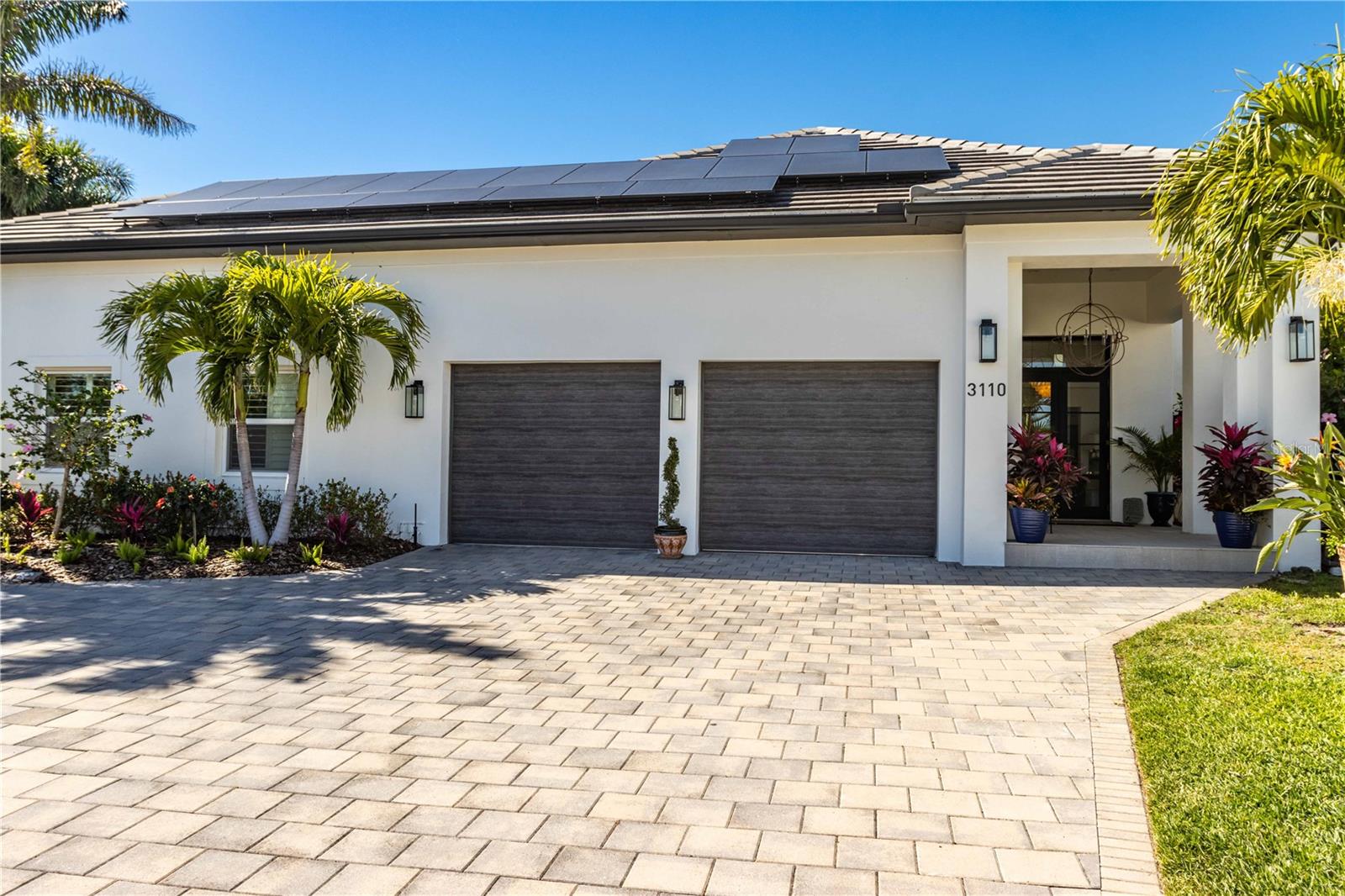 One or more photo(s) has been virtually staged. NEW PRICE ADJUSTMENT. The ultimate in coastal living! A fully renovated waterfront estate home with captivating water views of a protected cove and colorful sunsets daily! A prominent focal point is the spacious chef's kitchen, a culinary dream with top-of-the-line appliances, sleek stone countertops, a large center island, and a breakfast bar. The 900 sq ft covered lanai provides a lush outdoor entertainment area and private, additional living space with gentle cool gulf breezes wrapping around the property. The 160 feet of fenced seawall provides dolphin viewing access. Boating enthusiasts will delight in a private dock with a 16,000 lbs. boat lift, a floating dock for water sports, and additional mooring for a boat up to 50 ft. in length. Escape to the master bedroom suite featuring walk-in closets fit for royalty. King's closet (7x9). Queen's closet (14x15)! Fully renovated, well-appointed master bathroom with large shower and separate water closet.
Large private guestroom with adjacent full bathroom downstairs.  Additional upgrades include a walk-in wine cellar maintained at the perfect temperature by a Whisper-Kool system, Rinnai Tankless natural gas water heater and 22.2 KWH Solar Energy system installed July 2021 providing shelter from rising electricity costs. Many more additional features. If you are considering a waterfront lifestyle, this home is a must-see! Bedroom Closet Type: Walk-in Closet (Primary Bedroom).