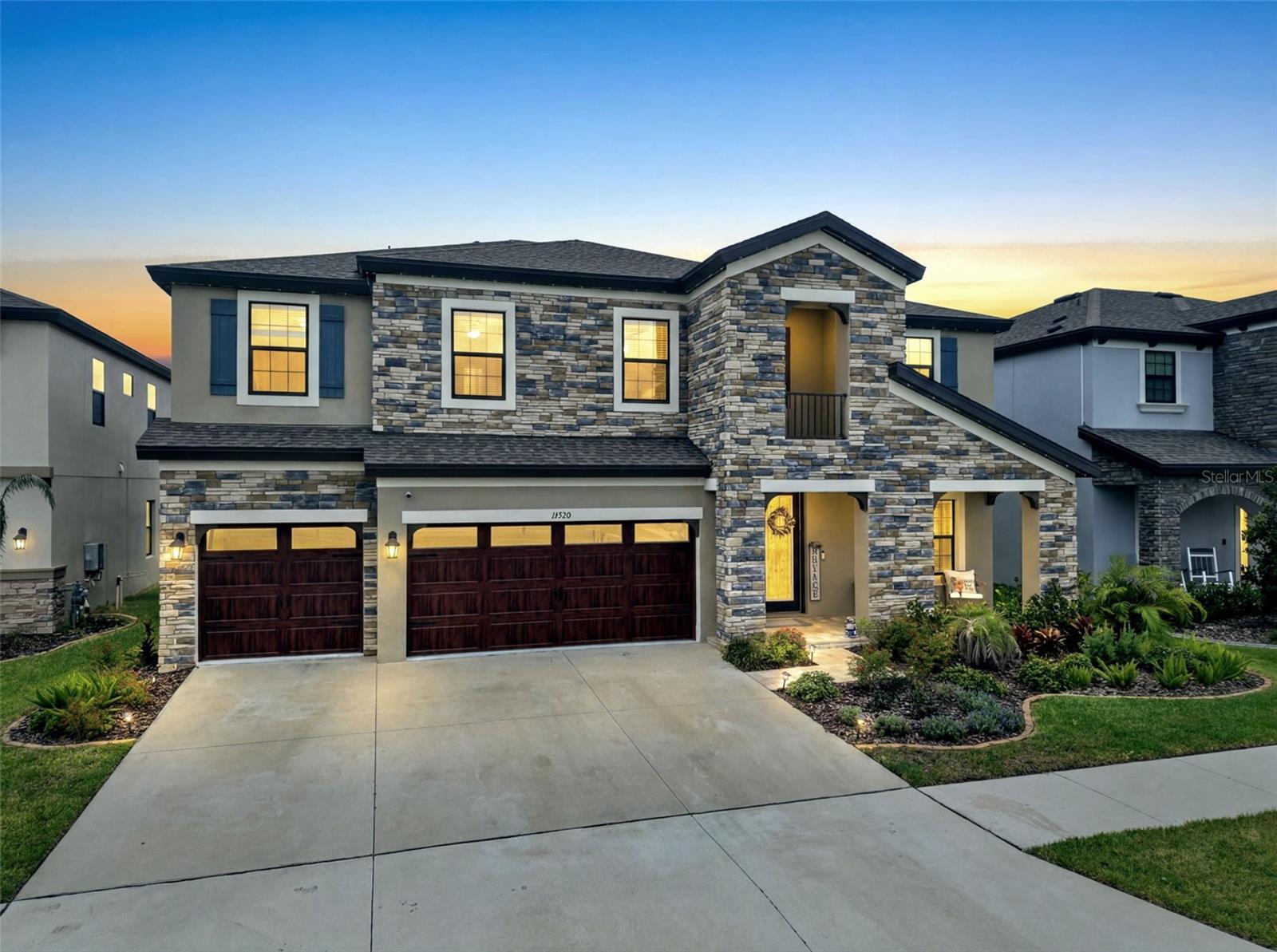 STUNNING HOME! Located in the master planned community of Hawkstone, this modern 2023 built home features 5 bedrooms, 4 full bathrooms, and a 3-car garage. Upon arrival, you'll notice the many exterior upgrades which include stacked-stone, wood-look garage door, front porch with pavers, and double glass front doors which allow for plenty of natural light. Step inside, into a desirable open floorplan with a spacious foyer and a private office with French doors near the entryway. WOOD LOOK TILE FLOORS AND HIGH CEILINGS THROUGHOUT! The kitchen has many appealing features, with a large extended island with seating space & pendant lights, quartz countertops, ample cabinetry with crown molding, tiled backsplash, walk-in pantry, farmhouse sink, stainless-steel appliances with a stainless rangehood, gas cooktop, and built-in oven! There is a bedroom and full bathroom on the main floor, perfect to use as a guest suite. Upstairs, is a BONUS ROOM for plenty of extra space to use as desired. The remaining bedrooms are upstairs with one of the bedrooms having its own private bathroom, and two of the bedrooms joined with a jack and jill bathroom which has a double sink vanity so everyone can have their own bathroom space! The Primary Suite has all you could ever want, with a luxurious ensuite bathroom with tile floors and a fully tiled walk-in shower with a built-in bench & frameless glass enclosure, separate garden tub, dual vanities each with sinks, and an oversized walk-in closet. The backyard has triple sliding glass doors leading to a covered screened-in lanai with pavers and ceiling fans to comfortably enjoy Florida living. There is also a Firepit, plenty of backyard space, and a private pond view! NO REAR NEIGHBORS! Hawkstone is Zoned for A-rated Barrington Middle School and Newsome High School! This community has so much to offer with amenities that include a dog park, two pools, playgrounds, clubhouse, sports courts, and many walking/biking trails. This home is a must see! Don't miss out, call today to schedule your private viewing!