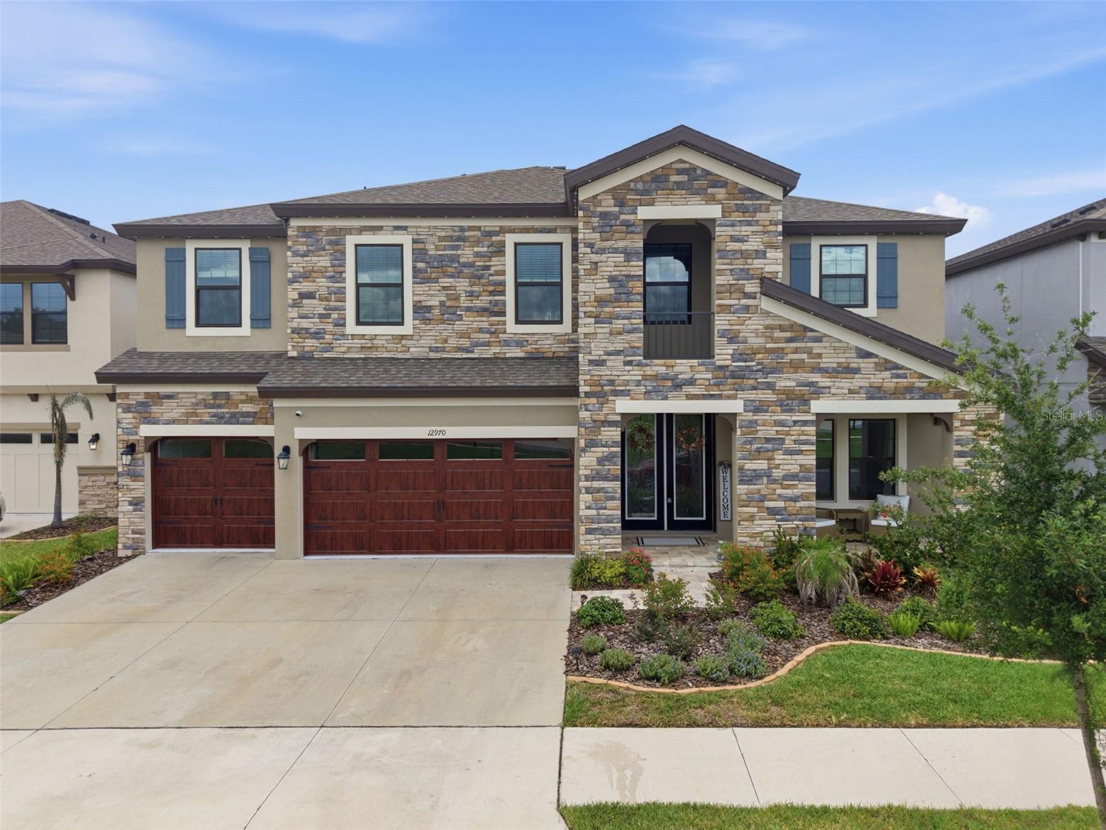 SELLER OFFERING BUYER CONCESSIONS! STUNNING HOME! Located in the master planned community of Hawkstone, this modern 2023 built home features 5 bedrooms, 4 full bathrooms, and a 3-car garage. Upon arrival, you'll notice the many exterior upgrades which include stacked-stone, wood-look garage door, front porch with pavers, and double glass front doors which allow for plenty of natural light. Step inside, into a desirable open floorplan with a spacious foyer and a private office with French doors near the entryway. WOOD LOOK TILE FLOORS AND HIGH CEILINGS THROUGHOUT! The kitchen has many appealing features, with a large extended island with seating space & pendant lights, quartz countertops, ample cabinetry with crown molding, tiled backsplash, walk-in pantry, farmhouse sink, stainless-steel appliances with a stainless rangehood, gas cooktop, and built-in oven! There is a bedroom and full bathroom on the main floor, perfect to use as a guest suite. Upstairs, is a BONUS ROOM for plenty of extra space to use as desired. The remaining bedrooms are upstairs with one of the bedrooms having its own private bathroom, and two of the bedrooms joined with a jack and jill bathroom which has a double sink vanity so everyone can have their own bathroom space! The Primary Suite has all you could ever want, with a luxurious ensuite bathroom with tile floors and a fully tiled walk-in shower with a built-in bench & frameless glass enclosure, separate garden tub, dual vanities each with sinks, and an oversized walk-in closet. The backyard has triple sliding glass doors leading to a covered screened-in lanai with pavers and ceiling fans to comfortably enjoy Florida living. There is also a Firepit, plenty of backyard space, and a private pond view! NO REAR NEIGHBORS! Hawkstone is Zoned for A-rated Barrington Middle School and Newsome High School! This community has so much to offer with amenities that include a dog park, two pools, playgrounds, clubhouse, sports courts, and many walking/biking trails. This home is a must see! Don't miss out, call today to schedule your private viewing!