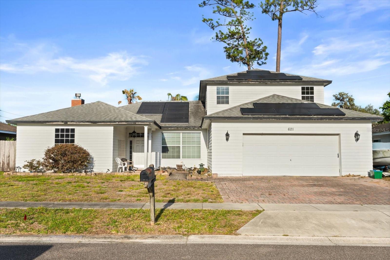 Welcome to 621 Prairie Ln, a spacious two-story home in Altamonte Springs with a practical layout, wood flooring, and abundant natural light throughout. The living room offers a welcoming central gathering space with a brick fireplace, ceiling fan, and large front windows. Nearby, the kitchen provides tile flooring, ample cabinetry, recessed lighting, dark countertops, and a breakfast bar, with the dining area positioned just to the left for an easy everyday flow. The primary suite includes bay-style windows, a ceiling fan, and an en suite bathroom with a walk-in shower, while the secondary bedrooms offer comfortable flexibility for guests, work, or everyday living. Upstairs, the unfinished bonus space is a true blank canvas with exciting potential for a large extra bedroom, expansive primary suite, studio, recreation area, or future finished living space, depending on the buyer’s needs. Outside, the covered rear patio with ceiling fans overlooks the fenced backyard and storage shed, creating a functional outdoor area with room to relax, entertain, and enjoy Florida's indoor-outdoor living. Conveniently located near major roadways, including SR 436, US-17/92, and I-4, this home offers easy access to shopping, dining, everyday conveniences, Altamonte Mall, Cranes Roost Park, and surrounding Central Florida destinations.