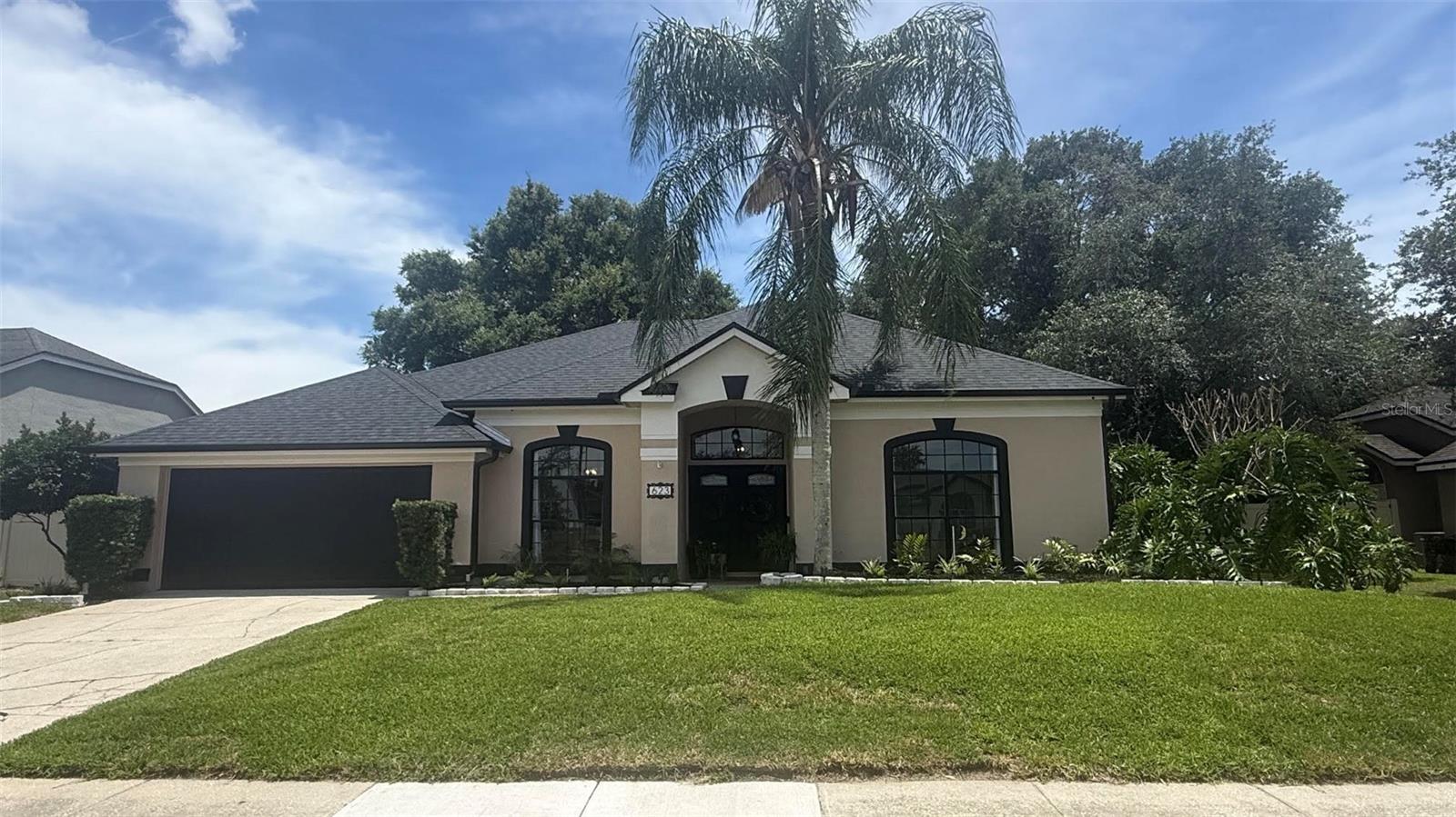 Tucked beneath a canopy of mature oaks in Oviedo's highly sought-after Bentley Woods community, this beautifully maintained pool home offers the perfect blend of privacy, comfort, and Florida outdoor living. From the moment you step inside, you'll appreciate the spacious split-bedroom floor plan, soaring ceilings, abundant natural light, and inviting living spaces designed for both everyday living and entertaining. The wood-burning fireplace creates a warm focal point, while large windows and sliding glass doors draw your attention to the backyard retreat beyond. The screened pool and lanai serve as the heart of the home, creating a true extension of the living space. Whether enjoying a quiet morning coffee, hosting gatherings and entertaining, or unwinding beneath the evening landscape lighting, the setting feels more like a private resort than a traditional backyard. The owner's suite offers direct access to the pool area and features a spacious ensuite bath with dual vanities, soaking tub, separate shower, and oversized closet. Three additional bedrooms and two full baths provide flexibility for guests, workspace needs or additional living space. Situated on a fully fenced homesite with mature landscaping and a two-car garage, this home offers the rare combination of privacy, functionality, and curb appeal. Conveniently located near top-rated Seminole County schools, UCF, shopping, dining, and major commuter routes. A move-in-ready opportunity in one of Oviedo's most established and desirable neighborhoods.