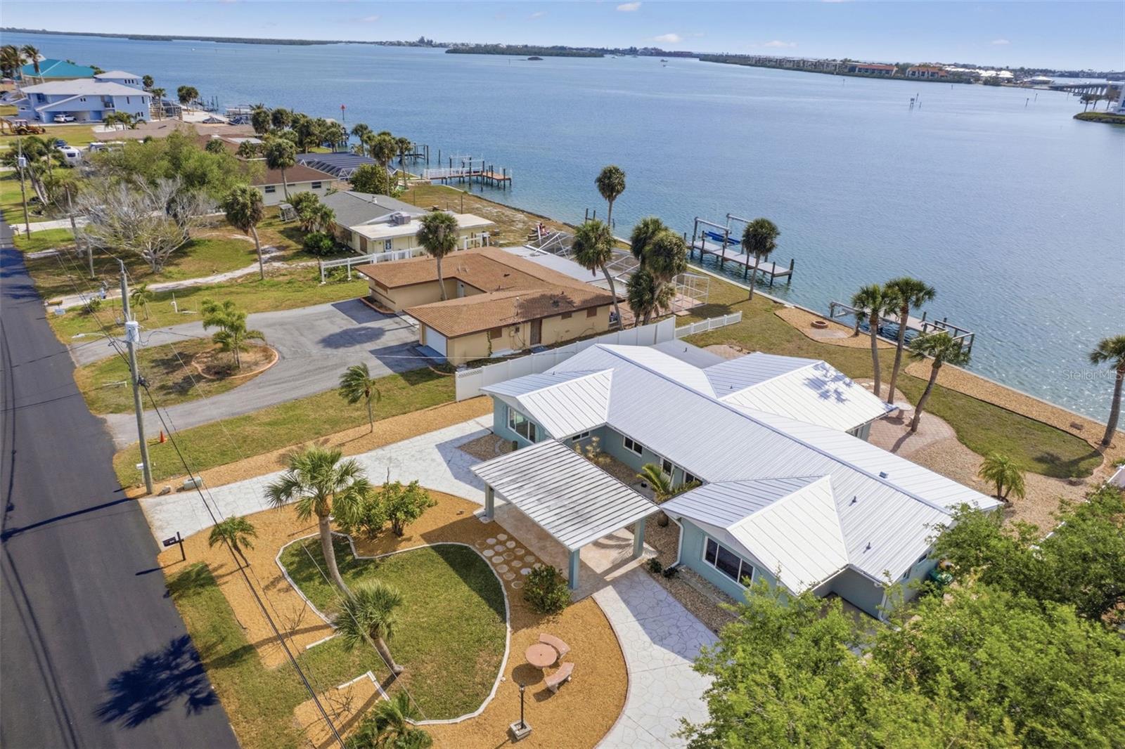 Waterfront living with DIRECT BAY ACCESS and breathtaking sunset views. NO BRIDGES. This beautifully reimagined residence offers prized western exposure and no-bridge access to the Gulf, delivering the ultimate boating lifestyle right from your backyard. This 4-bedroom, 2.5-bath home has been thoughtfully renovated to blend modern luxury with quality craftsmanship and effortless coastal comfort. At the heart of the home, a designer kitchen features custom solid wood cabinetry and an oversized quartz island with a dramatic waterfall edge and
continuous veining, complemented by a full-slab backsplash for a seamless, sophisticated look—perfect for entertaining or everyday living. Elegant ceramic tile flooring flows throughout, along with beautifully updated bathrooms featuring glass-enclosed showers and refined finishes. Beyond its visual appeal, the home offers true peace of mind with extensive upgrades, including new drywall, spray foam insulation, all-new drain lines, updated plumbing with overhead re-pipe and new fixtures, new electrical service, and professionally completed structural improvements. Additional enhancements include IMPACT hurricane windows and doors, a durable metal roof (2023), and a new A/C system (2024), providing efficiency, resilience, and low-maintenance living. Ideally located just a short bike ride to Englewood Beach (approximately 1 mile) and within walking distance to local restaurants, this home also places you near world-class fishing waters. The Englewood area is known as one of the top sport fishing destinations in the U.S., with nearby Boca Grande Pass globally recognized as the “TARPON FISHING CAPITAL OF THE WORLD.”   Step outside to embrace the waterfront lifestyle—boating, relaxing in the coastal breeze, and enjoying unforgettable sunsets from your WEST-FACING backyard. A rare opportunity to own a fully renovated waterfront retreat where luxury, location, and lifestyle converge.