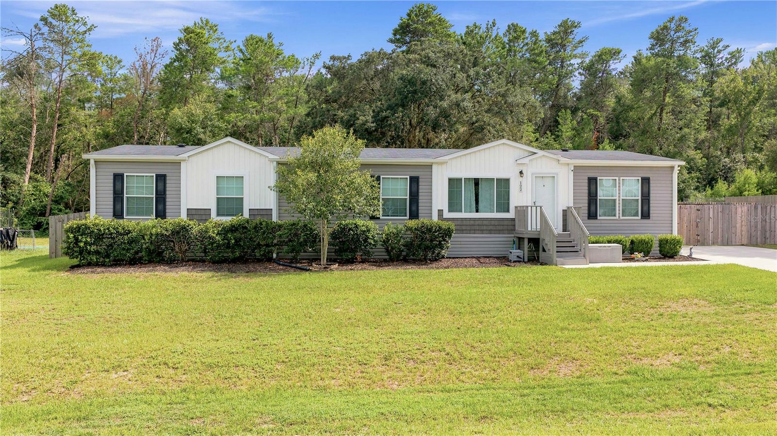 Welcome to this meticulously maintained and exceptionally cared-for 5-bedroom, 3-bathroom home offering over 2,100 square feet of comfortable living space designed for both everyday living and entertaining. From the moment you arrive, you'll appreciate the pride of ownership and the attention to detail that has gone into caring for this beautiful home. At the heart of the home is a beautifully designed kitchen featuring modern appliances, abundant cabinet and counter space, a convenient breakfast bar, and a custom coffee bar with additional storage. The kitchen opens seamlessly into the spacious living room, creating the perfect gathering place for family and friends. The thoughtfully designed split-bedroom floor plan provides added privacy, with the primary suite situated on one side of the home. The remaining four bedrooms are located on the opposite side, along with two additional full bathrooms, providing ample space for family members or guests. A standout feature of this home is the oversized family room, offering endless possibilities. Whether you're looking for an in-law suite, game room, home office, media room, homeschool area, or additional living space, this flexible room can easily adapt to your lifestyle. Just off the kitchen, the dining room provides a warm and inviting space for sharing meals while overlooking the backyard. Sliding glass doors lead to a large outdoor deck, making it easy to enjoy weekend barbecues, outdoor dining, or relaxing evenings under the Florida sky. The fully fenced backyard, complete with a double gate, offers plenty of room for entertaining, pets, gardening, or even storing recreational equipment,three storage sheds are also included, providing ample space for lawn equipment, tools, seasonal decorations, hobbies, or additional storage. Additional upgrades include an iSpring 6-stage reverse osmosis water filtration system with an alkaline drinking water system that supplies purified water to the kitchen sink and refrigerator for drinking water and ice. Conveniently located near grocery stores, restaurants, medical offices, shopping, and everyday essentials, this home also offers easy access to Silver Springs State Park, where you can enjoy crystal-clear springs, kayaking, hiking trails, and abundant wildlife. If you're looking for space, flexibility, and an ideal Central Florida location, this move-in-ready home checks all the boxes.