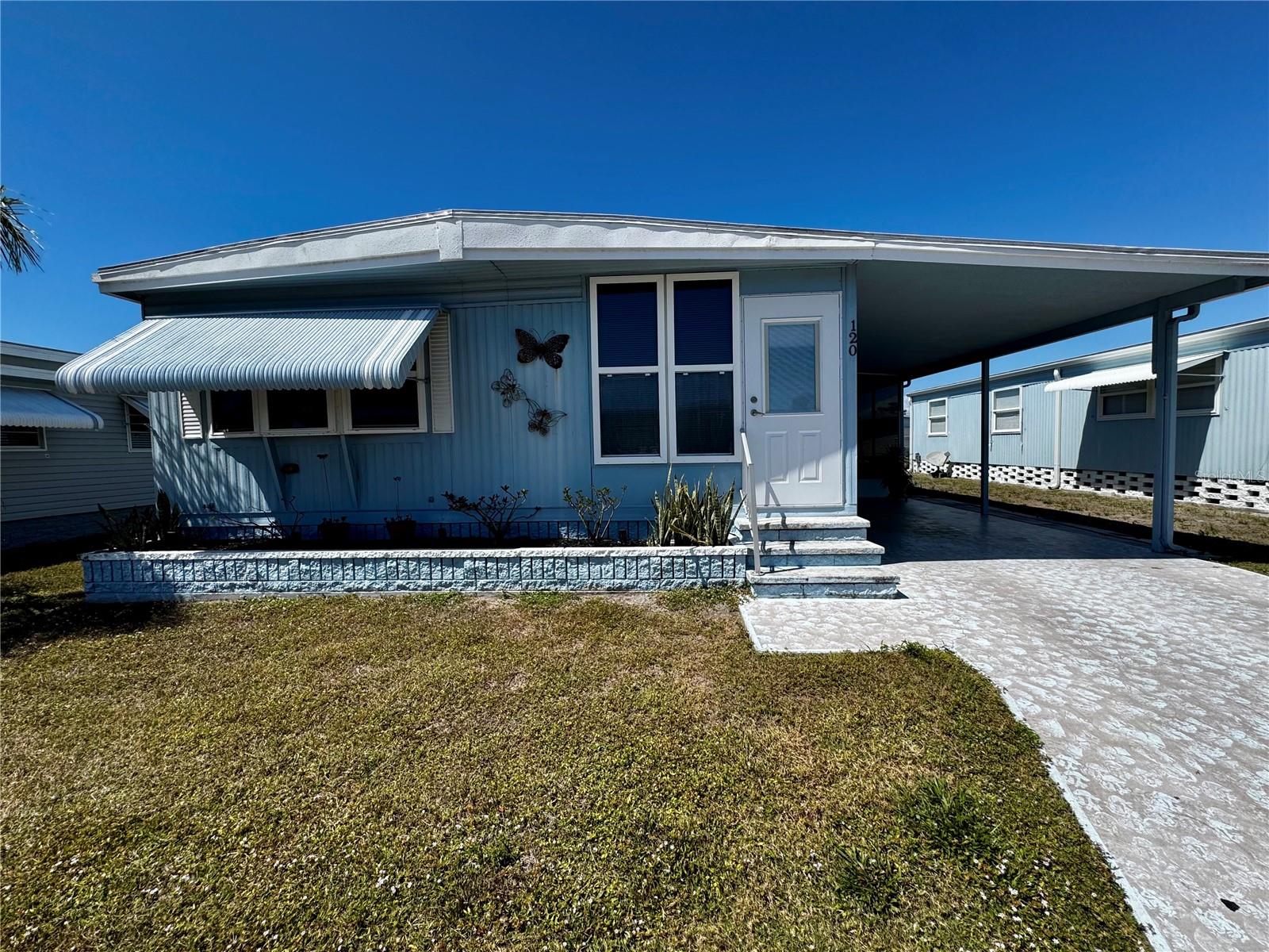 PARADISE IS AFFORDABLE!!! This well maintained, double wide manufactured home with ALL NEW KITCHEN APPLIANCES, QUARTZ COUNTERTOPS, BEAUTIFUL LAMINATE FLOORS, RECENTLY SCREENED OUTDOOR SITTING AREA, spacious layout, bright sunroom, and featuring 2 bedrooms, and 2 bathrooms is the perfect place to live the FLORIDA LIFESTYLE! Terra Ceia Manor is an active 55+ community where the land is owned by shareholders, SO NO LOT RENT, and the HOA fee of $199/month is one of the lowest in the area. The community has a heated pool and clubhouse, which is always buzzing with activity, including shuffleboard, billiards, card games, bingo, potlucks, social events, and so much more. World class beaches, shopping, restaurants, and airports are just a short drive away and commuting to Bradenton, Sarasota, and Tampa is convenient. Come and enjoy all this vibrant community has to provide...YOU DESERVE IT!!