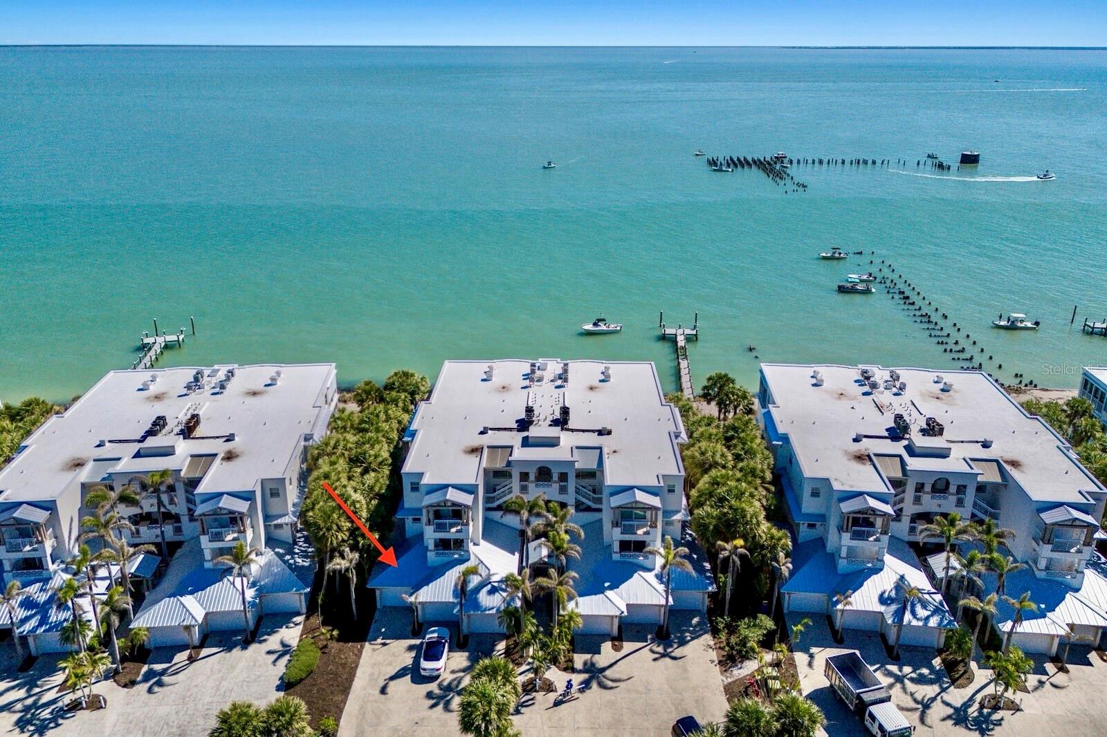 Welcome to your bayfront retreat in the highly sought-after community of Boca Bay! This first floor 3-bedroom, 3-bathroom condo offers 2,324 square feet of “one level” living space, offering an ideal blend of comfort and coastal charm.

Upon entering, you’ll be captivated by sweeping views of the serene bay waters, beautifully framed by expansive sliding glass doors that fill the open concept living and dining areas with natural light. Whether hosting guests or enjoying a quiet evening, the seamless indoor-outdoor flow and spacious design make this residence ideal for relaxed waterfront living.

The primary suite is a peaceful retreat, complete with its own private balcony, breathtaking bay views, and stunning sunrises. The suite also features two large closets and an ensuite bathroom with a soaking tub, walk-in shower, and dual vanities. 

Two additional generously sized bedrooms, each with their own ensuite bathroom, provide comfortable accommodations for family and guests, ensuring everyone enjoys their own private space.

Unwind on the spacious bayside lanai, thoughtfully designed with a built-in grill and wet bar area, the perfect setting for entertaining friends and family or savoring quiet moments with a waterfront backdrop. A private garage with direct access into the condo adds an extra level of convenience.  

As a resident of Boca Bay, you’ll enjoy exclusive access to an impressive array of amenities, including a private beach club, multiple swimming pools, tennis and pickleball courts, a fitness center, and the renowned Boca Bay Pass Club, all just moments from your doorstep.