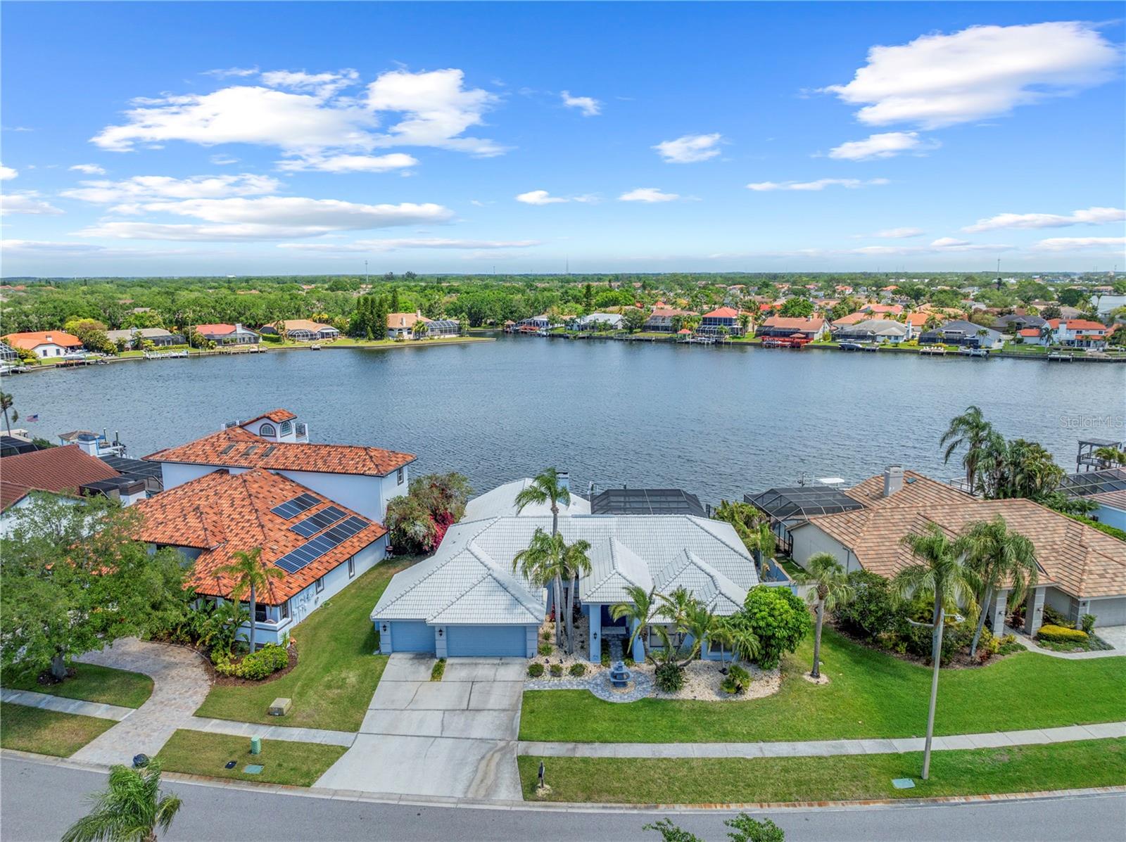 WATERFRONT HOME with DOCK/LIFT... Located in BAYSIDE!!! This beautiful Athur Rutenberg home offers a 4 BEDROOM + OFFICE, 3.1 BATH, 3,303 sq. ft. home in BAYSIDE! Situated on a SPECTACULAR LOT WITH OPEN WATER VIEWS AND DIRECT ACCESS TO TAMPA BAY AND THE GULF, this property features an open floor plan with neutral decor and volume ceilings. Many updates during the last few years including KITCHEN, MASTER BATH AND CUSTOM MASTER BEDROOM CLOSETS, FLOORING. Home also includes POOL and SPA with large lanai and PAVERS and OUTDOOR KITCHEN. Updated LAUNDRY ROOM. NEW DOCK AND LIFT in 2019. Bayside, a gated community, offering tennis courts, basketball courts. This home also offers a convenient location for schools (BERKELEY PREP only 5 mins away), lots of shopping, dining, beaches, and quick access to TIA.