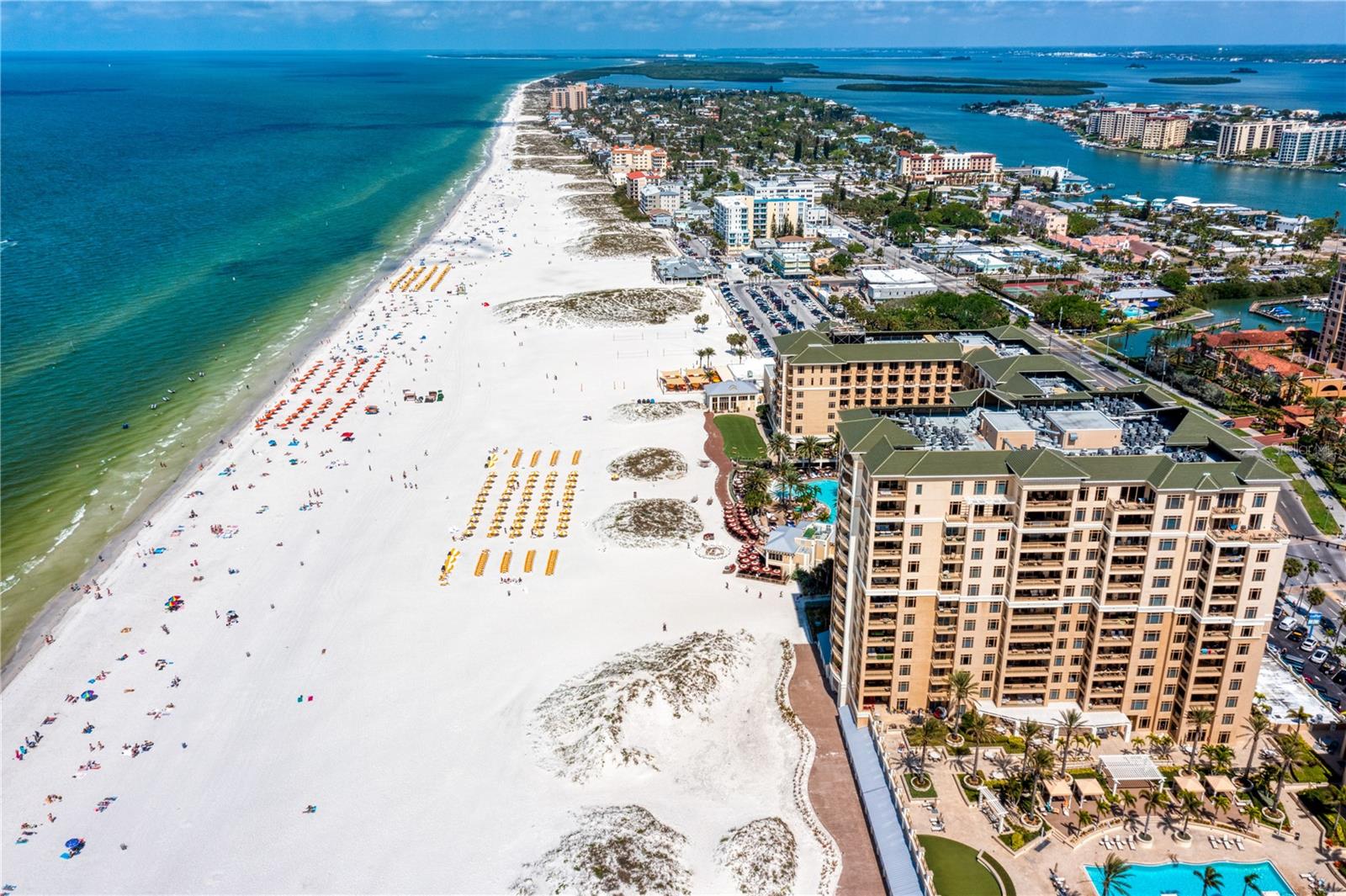 Welcome to the Residences at Sandpearl, where luxury meets the Gulf Coast lifestyle on Clearwater Beach. This exquisite corner Gulf-front unit offers just over 2,600 square feet of elegant living space, perfectly positioned to capture breathtaking views of the Gulf of Mexico.  This stunning 3-bedroom, 3.5-bathroom residence invites you to step into a world of refined coastal living. The open-concept living and dining area is designed for both comfort and style, featuring high-end finishes and ample space for entertaining. The gourmet kitchen is a chef's dream, equipped with top-of-the-line appliances, a breakfast bar, and mesmerizing water views that create the perfect backdrop for any meal.  Enjoy your morning coffee or evening cocktail on one of the unit's spacious terraces, each offering spectacular vistas of the shimmering Gulf waters. The luxurious primary suite provides a serene retreat with a spa-like ensuite, complete with double vanities, a jetted tub, a walk-in shower, and generous walk-in closets.  Additional features of this premier residence include 1 assigned under-building parking space, a climate-controlled storage unit, and access to a beachside cabana, ideal for storing your beach essentials. The Sandpearl Residences are more than just a place to live; they provide a lifestyle of unparalleled luxury and comfort. Residents enjoy exclusive amenities such as a 24/7 Concierge, gathering rooms, a billiards room, a conference room, a state-of-the-art fitness center, bike storage, a whole-building water softener, and a beachfront pool with expansive areas for relaxation and entertainment. Located in the heart of Clearwater Beach, you're just moments away from local shopping, fine dining, and the world-famous white sand beaches. Whether you're seeking a full-time residence or a vacation home, this property at Sandpearl Residences offers a unique opportunity to experience the very best of beachfront living. Don't miss your chance to own a piece of paradise in this gulf front community.