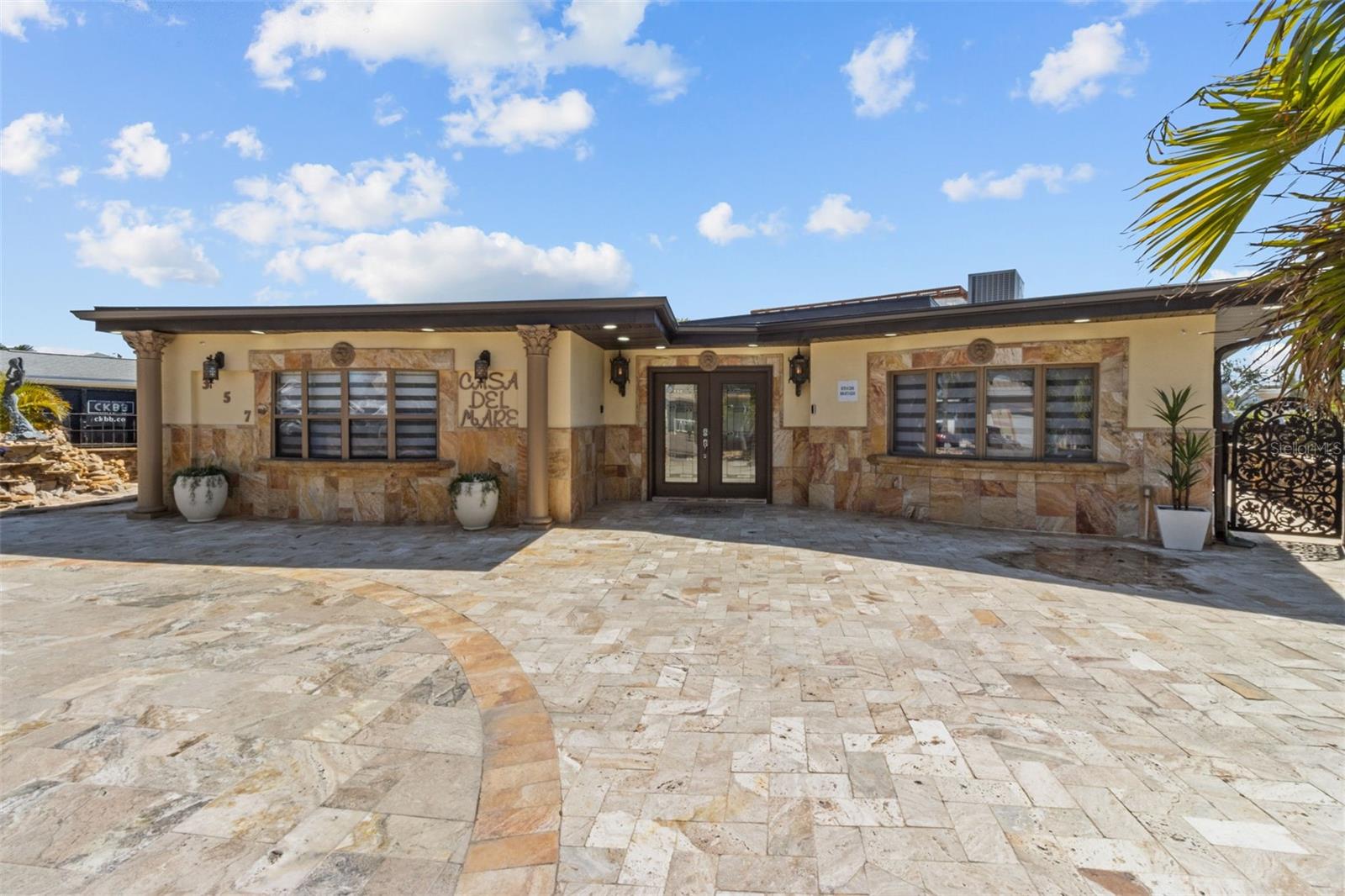 Welcome to “Casa Del Mare” – a one-of-a-kind architectural sanctuary located in the heart of Indian Rocks Beach. Step inside to discover a 3-bedroom, 2-bath residence with a thoughtful split-bedroom layout, offering privacy and comfort for owners and guests alike. The interiors feature custom tile flooring, upgraded solid-core interior doors, and exquisite stonework throughout — with granite, marble, and Tavernier stone finishes used to dramatic effect. What truly sets this home apart is its uniquely themed, fully furnished, move-in-ready design — every room curated with intention, artistry, and character. “Casa Del Mare” delivers an immersive coastal experience that immediately captivates guests. From sculptural stone details to bespoke décor, each space feels like stepping into a boutique resort. This is the kind of home that sparks conversation, creates instant “wow” moments, and leaves visitors absolutely stunned. The gourmet kitchen is equipped with commercial-grade appliances, gas cooking, and stone-wrapped detailing that elevates everyday living and entertaining. In addition to its exceptional design, “Casa Del Mare” has a proven history as a highly successful short-term rental, outperforming many comparable coastal properties in occupancy, guest satisfaction, and repeat bookings. Its layout, amenities, and resort-style atmosphere make it especially desirable for travelers seeking a luxury experience — offering the next owner both lifestyle enjoyment and top-tier income potential. Each bath is designed as a spa retreat, featuring oversized showers with multi-shower heads, rain and waterfall-style features, and meticulous stone craftsmanship. Outdoors, this property truly shines. Enjoy the rooftop lounge and spa deck, resort-style pool with sun shelf, outdoor kitchen and bar, plus a private dock featuring a new 12,000-lb boat lift installed December 16, 2024, along with a floating dock for multiple personal watercrafts — ideal for boating, sunset cruising, or hosting during the IRB holiday boat parades. Additional recent upgrades include a new roof installed June 27, 2024, and a new air conditioning system installed December 11, 2023, providing peace of mind and enhancing the home’s long-term value. “Casa Del Mare” is equally suited for full-time coastal living, a private retreat, or a high-performing luxury investment property. Every space has been curated to evoke relaxation, conversation, and connection — with room to gather, entertain, and create lasting memories. This is more than a home — it’s an experience.