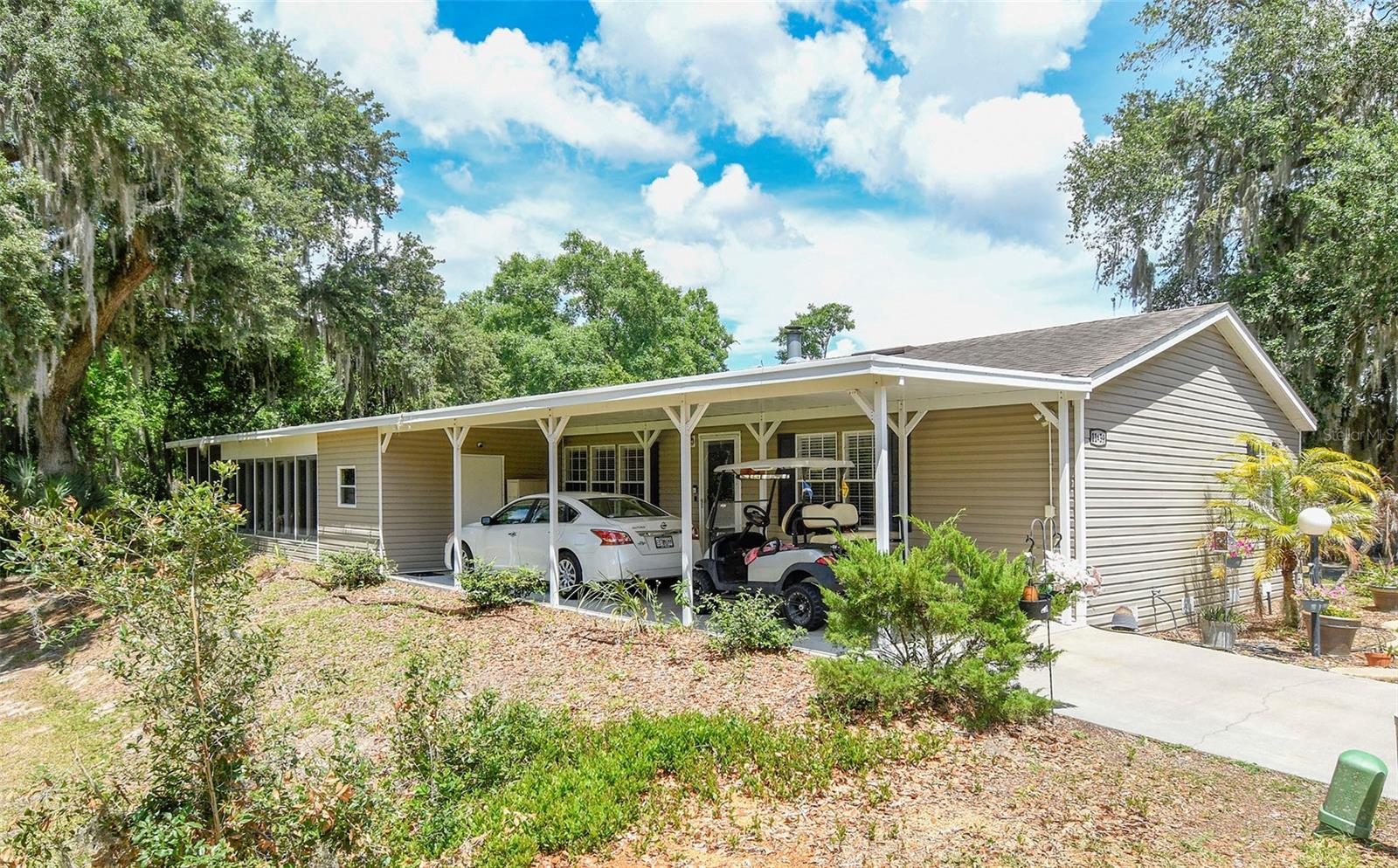 FIXED PRICE Welcome to a wonderful established neighborhood. Lake Yale is a great place to live. You will get to know your neighbors quickly at one of the many arranged events. The home has one of the best locations in the community. There is a glazed sunroom that overlooks green areas and to the rear you can relax on the screened lanai overlooking the trees. The house is large.  1664 sq ft with the enclosed screen room of 220 sq ft. brings the total area up to 1884 sq ft. A wonderful house in which to live.  It sits on one lot which you own and has only one HOA fee of $165 each month. For that you get your grass cut and the fee also provides for the association facilities. Clubhouse with meeting room, kitchen, library with pool table and outside a swimming pool and spa. In the rear, there is a shuffleboard court and a dock onto Lake Yale. You can fish from there and if you wish you can have a boat dock. A wonderful place to enjoy retirement. The floors in the living room and three bedrooms are wood. Vinyl in the large kitchen/diner, utility room, and bathrooms and the only room with carpet is in the sun lounge. On the rare cold evening in the winter, there is a fireplace. The home is easily maintained. To the side there is a long covered carport with a storage unit at the end. The home and location have everything that you could desire in a home.