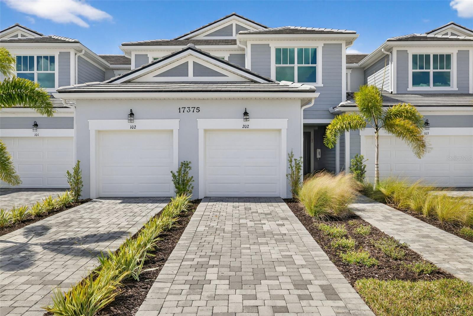 Discover the inviting comfort of this Seabright II second-floor coach home offering 2 bedrooms, 2 bathrooms, and a 1-car garage in a thoughtfully designed, light-filled layout. A private staircase leads to an expansive main living area where 12x24 stone-inspired tile flows in a stylish staggered pattern, creating a warm modern backdrop that extends through the great room, dining area, and kitchen. Soft white shaker cabinetry, off-white quartz with subtle gray veining, and a herringbone-pattern backsplash give the kitchen a clean, designer feel, perfectly complemented by a spacious island ideal for everyday meals or casual entertaining. The serene primary suite features a large walk-in closet and a spa-like primary bathroom with dual sinks, floor-to-ceiling tile, and a beautifully finished shower with coordinating mosaic tile floors. A guest bedroom and full bathroom offer comfortable separation, while the dedicated study provides flexibility for work, hobbies, or relaxation. Additional highlights include 8-foot interior doors, an upgraded trim package, a screened lanai, and a conveniently located laundry room. Residents enjoy access to a resort-style pool, shaded cabana spaces, an event lawn for outdoor activities, a dog park, a playground, and scenic walking paths—plus close proximity to a nearby waterfront dining district, weekly community events, outdoor recreation, and sun-drenched Gulf-coast beaches. Photos, renderings and plans are for illustrative purposes only and should never be relied upon and may vary from the actual home. Pricing, dimensions and features can change at any time without notice or obligation. The photos may be from a furnished model home and not the home offered for sale.
***Photos, renderings and plans are for illustrative purposes only and should never be relied upon and may vary from the actual home. Pricing, dimensions and features can change at any time without notice or obligation. The photos may be from a furnished model home and not the home offered for sale.