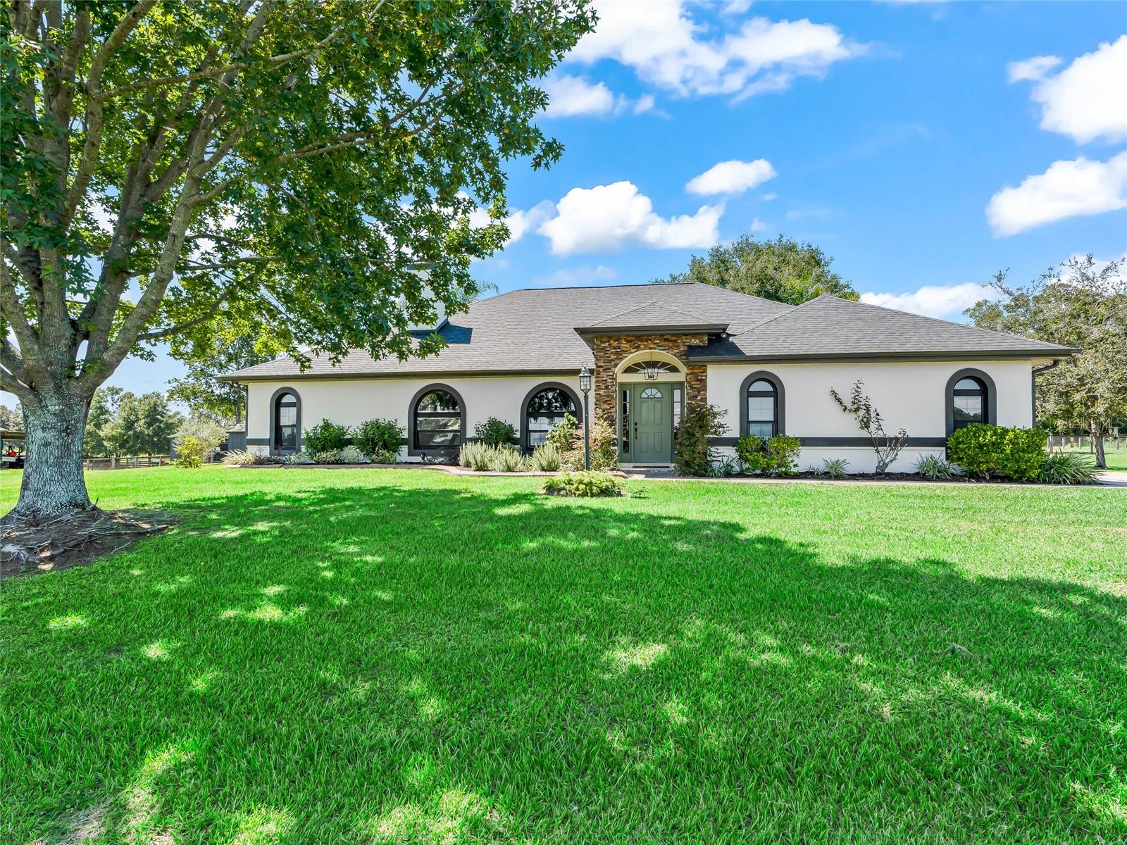 Welcome to this impeccably maintained 17-acre working farm, offering the perfect blend of comfort, functionality, and prime location. The immaculate 3-bed, 2-bath home features a new roof and windows (2025), along with fully renovated bathrooms (2025), ensuring a modern, move-in-ready feel. A whole-house generator provides peace of mind year-round.Equestrian facilities are exceptional, starting with the 8-stall barn complete with a spacious tack room and a separate feed room. The property includes 12 well-appointed paddocks, 8 equipped with lean-tos, plus a Eurowalker for conditioning. A perfectly situated area awaits your custom riding arena, making this an ideal setup for training, boarding, or private use.Located just minutes from I-75, the Florida Horse Park, and the Greenway trails, this farm offers unmatched convenience for riders and commuters alike. Beautifully maintained and thoughtfully designed, this is a turnkey opportunity in one of the area’s most sought-after equestrian communities.