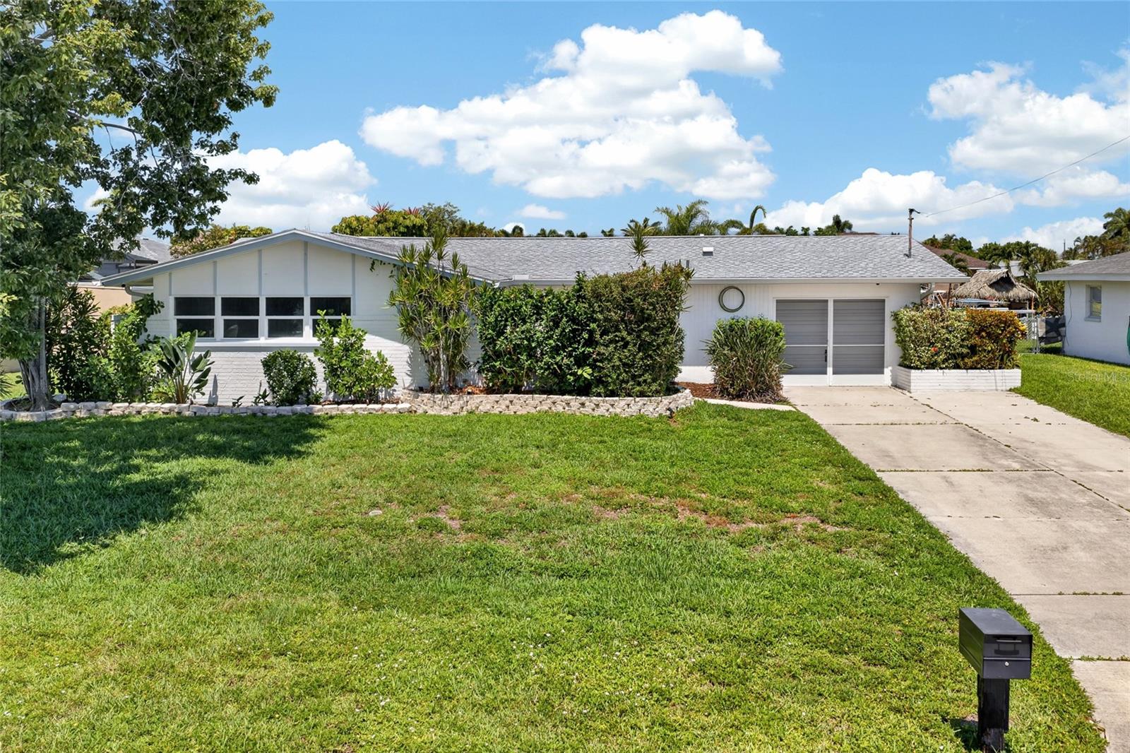 WATERFRONT POOL HOME IN THE HEART OF CAPE CORAL! Welcome to this beautifully maintained 3 BEDROOM, 2 BATHROOM HOME offering the perfect blend of comfort, style, and the ultimate Florida boating lifestyle. Situated on 80 FEET OF WATERFRONT, this exceptional property features a CONCRETE DOCK AND SEAWALL WITH BOTH WATER AND ELECTRIC, making it easy to keep your boat ready for your next adventure. With a SHORT BOAT RIDE TO OPEN WATER, you'll enjoy convenient access to world-class boating, fishing, and waterfront dining.

Step inside to discover a bright and inviting floor plan featuring LUXURY VINYL PLANK FLOORING THROUGHOUT THE MAIN LIVING AREAS AND BEDROOMS, creating a seamless and modern look. The beautifully updated kitchen serves as the heart of the home and features GRANITE COUNTERTOPS, STAINLESS STEEL APPLIANCES, ample cabinetry, and a functional layout designed for both everyday living and entertaining.

The spacious primary suite offers a relaxing retreat complete with a WALK-IN CLOSET and DIRECT ACCESS TO THE POOL AREA, allowing you to enjoy the Florida lifestyle from the moment you wake up. The updated guest bathroom adds a fresh, modern touch for family and visitors alike.

One of the home's standout features is its seamless indoor-outdoor living. DOUBLE POCKET SLIDERS open the living area to the screened lanai, creating an expansive entertaining space perfect for gatherings or simply enjoying the beautiful waterfront views. The SCREENED POOL is equipped with a HEAT PUMP, allowing for comfortable swimming throughout much of the year.

Outside, you'll appreciate the MATURE, WELL-MAINTAINED LANDSCAPING that enhances the home's curb appeal while creating a lush tropical setting. Whether relaxing by the pool, enjoying the water views, or heading out on the boat, this property truly embodies the Southwest Florida lifestyle.

Additional peace of mind comes from a NEW A/C SYSTEM INSTALLED IN 2025, providing comfort and efficiency for years to come.

Conveniently located near shopping, dining, entertainment, golf courses, and Cape Coral's many parks and marinas, this move-in-ready waterfront home offers everything you've been searching for.

DON'T MISS YOUR OPPORTUNITY TO OWN THIS BEAUTIFULLY UPDATED GULF-ACCESS POOL HOME WITH 80 FEET OF WATERFRONT AND A SHORT BOAT RIDE TO OPEN WATER!