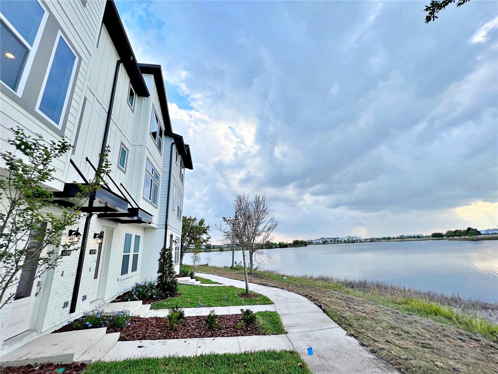 WATERFRONT TOWNHOME! This 3 bedroom townhome is located in the vibrant Laureate Park at Lake Nona. HIGHLY DESIRED ASHTON WOODS FLOORPLAN with OVER 1,998 SQFT and 40K+ in MODEL UPGRADES!! This three story townhome features STUNNING WATER VIEWS with a bedroom, full bath, and garage on the first floor. Great room design on second story with living room overlooking the GOURMET KITCHEN and opening up to the dining room and PRIVATE BALCONY. Kitchen features 42' LEVEL 4 LIGHT TONED CABINETS and UPGRADED LEVEL 4 QUARTZ COUNTERTOPS including stainless steel appliances. VINYL PLANK FLOORING throughout living areas. Third level features master suite, master bath, as well as secondary bedroom and bath. All bathrooms highlight stunning LEVEL 4 CABINETS and QUARTZ COUNTERTOPS. HOA INCLUDES: fiber-optic speed internet & LP Fit Gym membership. The community also features access to the resort-like state-of-the art Aquatic Center with two swimming pools (family pool & quiet pool) and sand volleyball court, Canvas Restaurant and Café, Lake House event venue, community gardens, dog parks, and trails perfect for walking, running and bicycling. Located within desired A-rated schools! Conveniently situated near major highways, 417, 528, turnpike, and Orlando International Airport. Close proximity to Medical City, including UCF Medical School, Sanford- Burnham Institute, Veterans Affairs Hospital, Nemours Hospital, MD Anderson Cancer Center, US Tennis Association national headquarters and Lake Nona Country Club. This home will not last long, schedule your appointment today!