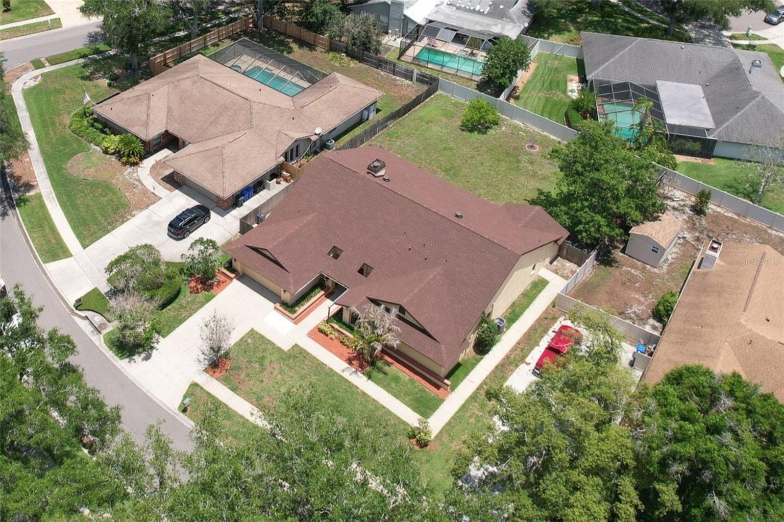 One or more photo(s) has been virtually staged. Rarely does a home offer this much space, flexibility, and value in the heart of Lake Magdalene. Featuring 5 bedrooms, 4 bathrooms, a 2-car garage, over 3,300 square feet of living space, NO CDD, Flood Zone X (NO flood insurance required), this impressive residence sits on a generously sized 0.32 acre homesite with a huge fenced backyard and is surrounded by the beautiful oak tree-lined streets that make Lake Magdalene Manors one of Tampa's most established and sought-after communities.


Step inside to a grand entrance with soaring vaulted ceilings, fresh interior paint throughout, and an open, light-filled floor plan designed for both everyday living and entertaining. The expansive layout features a formal living room, dining room, oversized family room, and a large kitchen that seamlessly connects the home's main gathering spaces, a breakfast dinette area and a large laundry room with many built-in cabinets. A cozy wood-burning fireplace serves as a warm focal point at the center of the home, creating the perfect setting for family gatherings and holiday celebrations.


The thoughtfully designed split-bedroom floor plan provides privacy and functionality, while a private IN-LAW SUITE with its own SEPARATE ENTRANCE offers exceptional flexibility for MULTIGENERATIONAL LIVING, long-term guests, a home office, or private accommodations for extended family.


Major recent improvements include a BRAND-NEW ROOF, NEW ELECTRIC WATER HEATER, and a FULL INTERIOR REPAINT in Sherwin-Williams' popular City Loft color, providing peace of mind for years to come.


Step outside to the covered and screened lanai, an ideal space for year-round Florida entertaining. The oversized fenced backyard offers endless possibilities with ample room for a custom pool, outdoor kitchen, play area, or private backyard retreat. Adding to the property's appeal are mature fruit-producing avocado and starfruit trees, creating a backyard that is both beautiful and functional.


Large homes with this level of square footage, versatility, and outdoor space are becoming increasingly difficult to find in established Tampa neighborhoods. Whether you're looking for room to grow, room to entertain, or simply room to breathe, this exceptional property delivers.


Conveniently located near shopping, dining, hospitals, entertainment, parks, major roadways, and Tampa International Airport, this is a rare opportunity to own a substantial home in one of Tampa's most desirable established communities.