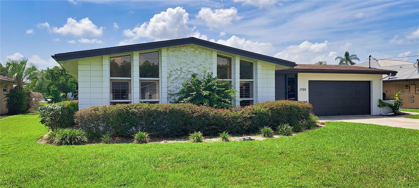 Beautifully Remodeled 4 Bedroom MID-CENTURY MODERN CANALFRONT Home with Private Pool! Direct access to CLEAR LAKE, Orlando's Most CENTRAL TRUE SKIABLE LAKE, only 4 Miles from Downtown Orlando! Keep your BOAT directly behind your home with easy no bridge access to the lake from your private seawall! This Backyard OASIS features a Private Swimming Pool with Beautiful Paver Deck, Huge Covered Lanai area with built-in BBQ, all situated on nearly a 1/4 Acre fenced lot. Peaceful Canal Views where you can Relax, Listen to the Birds, and Soak in Nature every day. Inside, you'll love the Tastefully Updated Open Floor Plan featuring a Stunning Kitchen with Tall Soft Close Shaker Cabinets, Stainless Steel Appliances, and Gorgeous Granite Countertops throughout both the kitchen and bathrooms, perfectly blending style, function, and Timeless Elegance. The Wonderful Layout offers a Large Open Family Room, Vaulted Ceilings, Recessed Lighting and Luxury Vinyl Plank Flooring throughout the home. There’s a 2nd additional Living Area and multiple areas for dining. The well located primary bedroom has access to the Lanai pool area and a walk-in closet with built-ins you’ve only dreamt of! All these Wonderful home features provide exceptional flexibility for both everyday living and entertaining your friends. This Iconic Mid-Century Design combines Premium Finishes with Modern Designer Upgrades to create an Impressive Home for you to enjoy! The Isle of Catalina community provides access to the Community-Owned Private Waterfront Complex featuring a Private Electronic Gated Boat Ramp, Recreational Building, Volleyball Court, Picnic Tables, and Incredible Views of the Downtown Orlando Skyline across the 358 acre Clear Lake, the Second Largest Lake in Orlando all for HOA dues of only $197 per year. Enjoy Boating, Water Skiing, Wakeboarding, Beautiful Sunsets, and a True Waterfront Lifestyle right in the heart of the city! This SUPER CENTRAL Location offers some of the Best Access to Orlando’s Restaurant and Entertainment Districts and I-4, only minutes from Universal Studios, CityWalk, , Mall at Millenia, SODO Shopping, LA Fitness, Planet Fitness, International Drive, SeaWorld, Walt Disney World, Sand Lake Restaurant Row, and Downtown Orlando. This is not only a home but a Lifestyle change, Boatable Opportunities like this are Rare!...don't miss your chance to own this GEM that perfectly combines a great Central location, Mid-Century Charm, Modern Luxury, and Unbeatable Orlando Waterviews and Sunsets!
