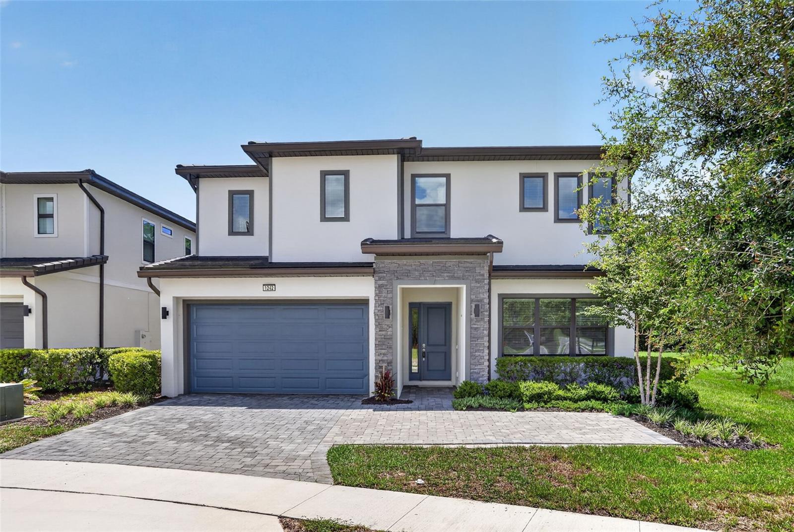 Luxury 12-Bedroom Short-Term Rental Opportunity Minutes from Disney – Zoned for 1-7 Day Leases in Guard-Gated Watersong Resort. Built in 2023 with 5,031 SF of heated living space, this two-story residence offers 12 bedrooms and 11.5 baths on a premium corner cul-de-sac lot with conservation on one side and no rear neighbors – rare privacy for a resort community. Offered unfurnished, the home is a blank canvas: design your own themed rooms and furnish to your brand standards, or make it your private multigenerational residence. The open floor plan features a chef's kitchen with double refrigerators, double dishwashers, double microwaves, and double sinks, built for large groups. First-floor primary suite plus an attached 1-bed/1-bath in-law suite. Outside, a screened private pool and spa with outdoor kitchen hookups anchor the entertaining space. Watersong amenities include a 24-hour guarded gate, clubhouse, resort-style community pool, and fitness center. Minutes to Disney, ChampionsGate golf and dining, and I-4, in one of Central Florida's most active vacation rental corridors. Flood Zone X. Highlights: 12 Bedrooms  11 Full Baths  1 Half Bath  Heated Private Pool & Spa  2023 Construction ,Corner Cul-de-Sac Lot with Conservation View, Short-Term Rental Zoning. Buyer or Buyer's agent shall independently verify all measurements, HOA restrictions, and short-term rental eligibility.