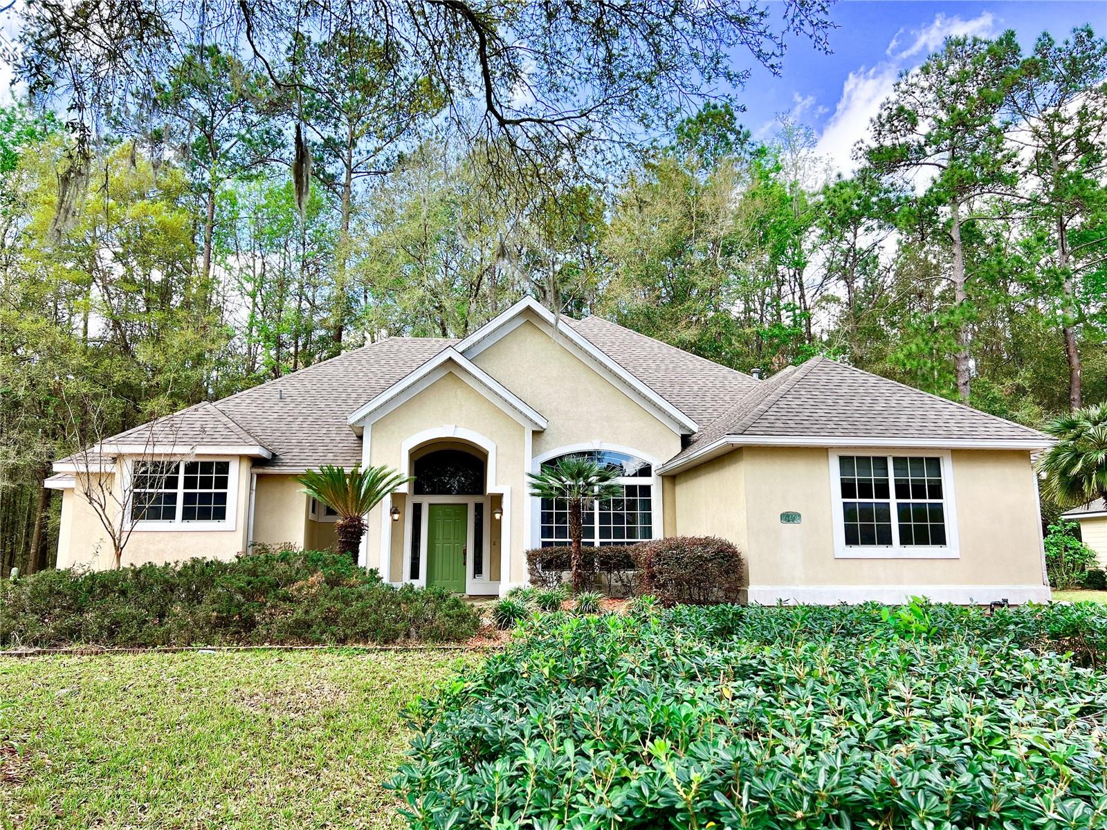 New to the market and backing up to the San Felasco Hammock Preserve State Park, you'll love this gorgeous custom-built 4 bedroom 2.5 bathroom home in the gated community of Turkey Creek. You will be impressed by the home's heated & cooled 2,449 sq ft of living space showcasing 12-foot-high ceilings with a total under roof area of 3,565 sq ft. This home boasts large windows throughout, welcoming in the natural light. Perfect for entertaining, the chef's kitchen comes with plenty of cabinet and counter space with granite countertops, stainless steel appliances and a breakfast bar. This home features crown molding and luxury trim upgrades throughout. You'll love the oversized master suite with its private back patio access. The master suite also features two walk-in closets, dual granite vanities, a walk-in shower and jetted tub. Transition out to the huge screened in patio and take in the breathtaking view, and enjoy the peace and serenity that backing up to San Felasco State Park provides. This home also offers a large 2 car garage and a separate garage entry for your golf cart or lawn mower. Additional features of this home include a newer roof and carpeting, a gas fireplace, separate laundry room, two-way split floorplan, and much more. Take advantage of amenities this premier community offers such as its golf course, community swimming pool, restaurant and tennis courts. Call today for a showing!