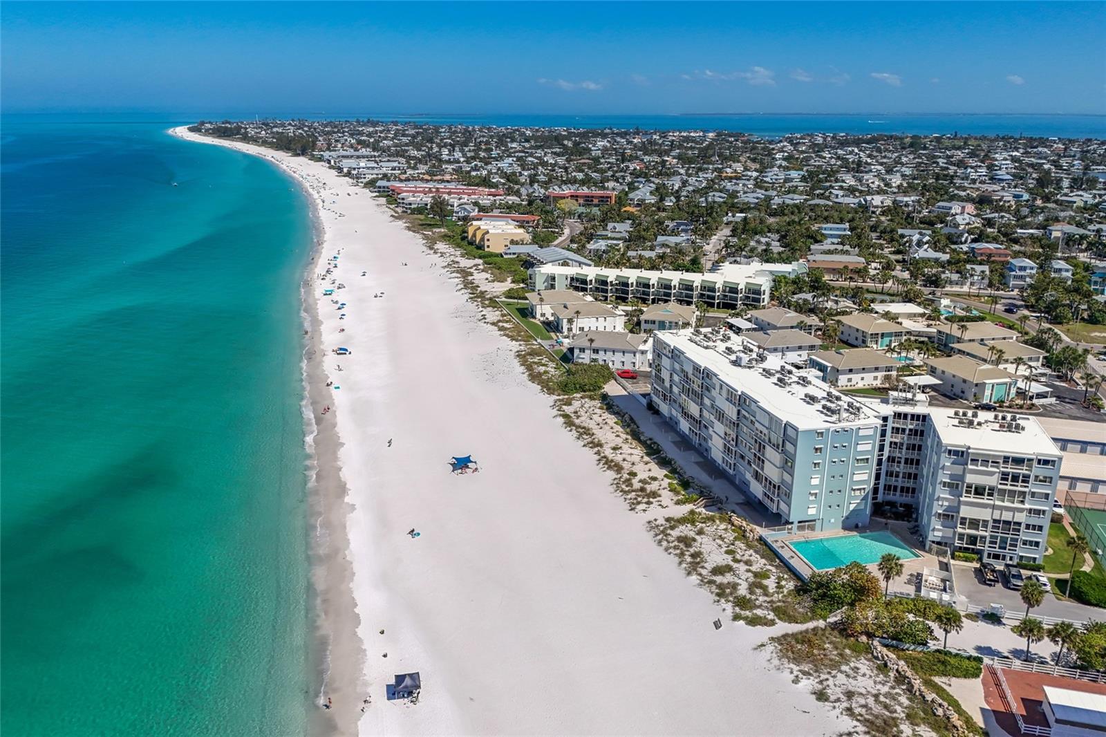 Sweeping Gulf sunsets, sugar-white sand, and the unmistakable charm of Anna Maria Island — now offered at a refreshed price. Perched on the 5th floor of the Martinique, this rarely available beachfront residence puts the entire horizon at your feet, where turquoise water stretches as far as the eye can see and the nightly sunset show never plays the same way twice.
Floor-to-ceiling glass pulls the Gulf straight into the open living space and primary suite, with sunlight shifting from gold to rose to amber across the day. Inside, a crisp coastal palette of stone countertops, shaker cabinetry, and a generous breakfast bar makes entertaining effortless, while two spacious bedrooms and two full baths offer comfort and privacy for family and guests.
Beyond your door, the Martinique delivers true resort living — heated beachfront pool, tennis courts, and direct access to powder-soft sand and the calm, shimmering Gulf. A deeded garage and private storage keep paddleboards, bikes, and beach gear at the ready.
And then there's the island itself. Anna Maria's seven-mile ribbon of old-Florida charm is yours to roam: hop the free island trolley to Pine Avenue's boutiques and cafés, cast a line off the beach, paddleboard the bayside flats, or settle in at the Sandbar for dinner with your toes in the sand. With no high-rises and a pace all its own, Anna Maria stays quietly, beautifully unchanged — the kind of place where seasons melt into one long coastal summer. A refreshed price on one of the Gulf's most coveted addresses. This is your spring to claim it.