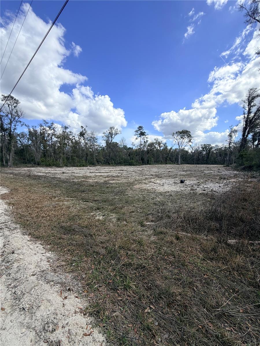 Offering 3.15 partially cleared acres in Dixie County, this property presents a rare opportunity to create the lifestyle you've been dreaming of. With much of the groundwork already in place—including a partially cleared homesite and access to water and electricity at a nearby lot—the property offers a head start toward building your custom home, weekend getaway, or future investment. The spacious acreage provides a blank canvas with plenty of room for gardens, outdoor living areas, recreational vehicles, boats, workshops, or all the extras that are often difficult to accommodate on smaller parcels. Enjoy the freedom to design your ideal property while taking advantage of the peaceful surroundings and wide-open space. Located near the heart of Florida's Nature Coast, you'll be just a short drive from the Suwannee River, renowned for boating, fishing, kayaking, and waterfront dining, as well as the Gulf of Mexico, offering world-class fishing and endless coastal adventures. Nearby attractions also include Manatee Springs State Park, where crystal-clear springs, scenic boardwalks, and abundant wildlife provide year-round opportunities for outdoor recreation. Whether you're ready to build now or planning for the future, this versatile property combines space, convenience, and potential, making it the perfect place to bring your vision to life.