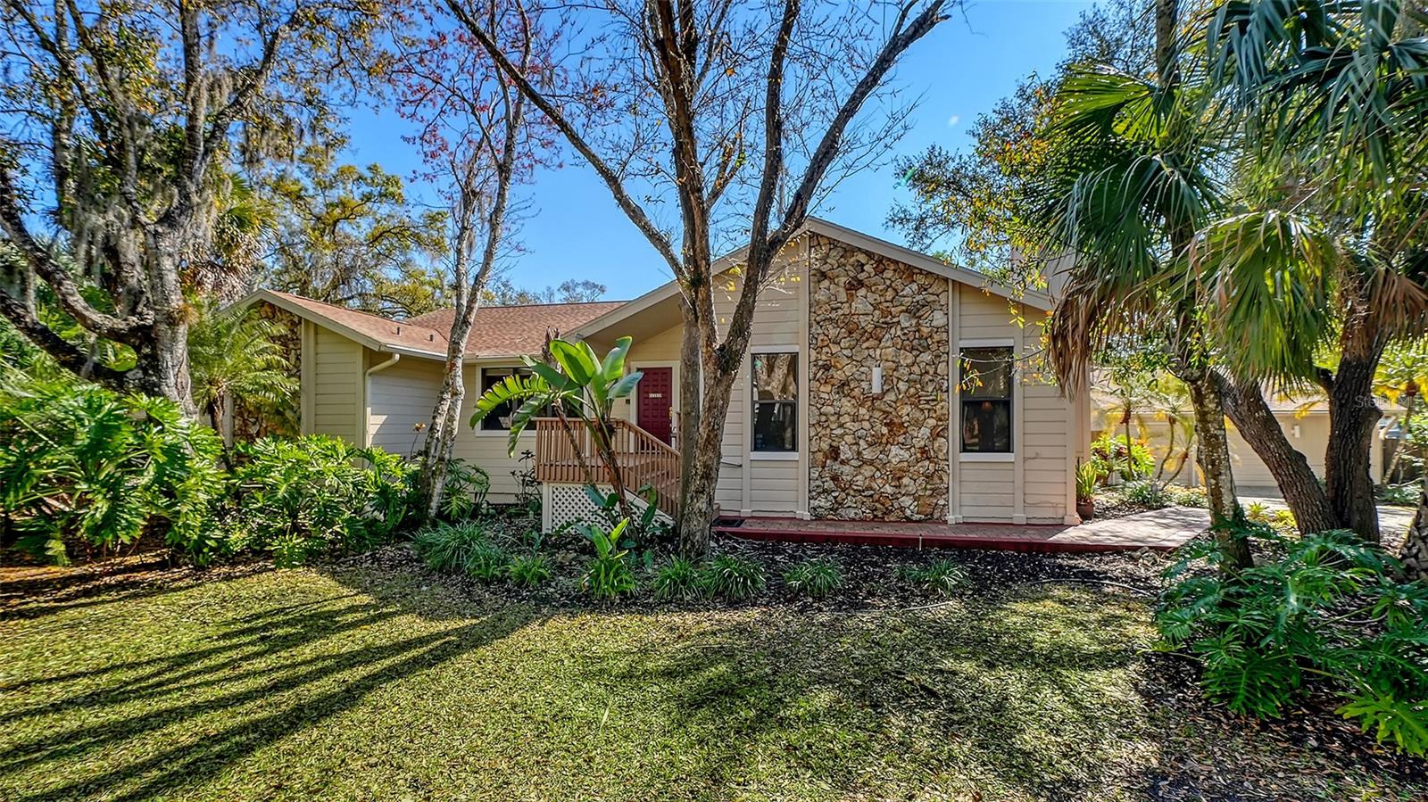 Welcome to Woodland Park – the charm of Old Florida in the heart of Sarasota! Set on an expansive 16,400+ sq. ft. lot with lush, mature landscaping, this spacious custom home offers privacy, character, and a warm community atmosphere along tree-canopied streets. Just 5
miles from downtown Sarasota, Woodland Park blends timeless “Old Florida” charm with everyday convenience. The home features a versatile split floor plan with generously sized rooms. The primary suite is thoughtfully separated from the guest bedrooms, offering comfort and retreat. Two fireplaces bring cozy charm—one anchoring the living room as a central gathering place, the other enhancing a flexible den/office space that could easily serve as a fourth bedroom. The living room is designed for entertaining, complete with a wet bar and open flow to the kitchen and dining area. Outside, a caged swimming pool invites year-round enjoyment, while a detached oversized two-car garage provides ample space for vehicles, storage, or a workshop. Recent updates include fresh exterior paint and a new roof, adding peace of mind to this already special property. With its unique floor plan, lush grounds, and community character, this home is a rare find in Sarasota.