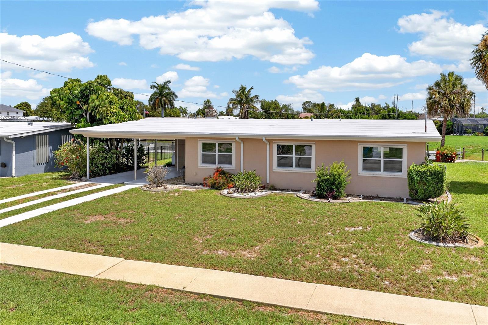 CHARMING WATERFRONT LIVING IN THE HEART OF PORT CHARLOTTE! Nestled along a peaceful canal in a quiet Port Charlotte neighborhood, this 3 BEDROOM, 2 BATHROOM WATERFRONT HOME offers the perfect opportunity to enjoy the laid-back Florida lifestyle. Featuring a PRIVATE DOCK, 7000-POUND BOAT LIFT, and inviting living spaces both inside and out, this home is ideal for boating enthusiasts, seasonal residents, or anyone looking to enjoy waterfront living.

Step inside and discover a warm, welcoming interior filled with natural light and timeless charm. One of the home's standout features is the spacious FLORIDA/FAMILY ROOM, complete with a beautiful STONE FIREPLACE that creates a cozy focal point and the perfect gathering place for relaxing with family or entertaining guests year-round.

The updated kitchen has been thoughtfully refreshed and features NEWER APPLIANCES, ample cabinetry, and a functional layout that makes meal preparation both convenient and enjoyable. It flows comfortably into the surrounding living spaces, making everyday living effortless.

The home offers THREE WELL-SIZED BEDROOMS, providing comfortable accommodations for family, guests, or a home office, while two full bathrooms add convenience and functionality.

Step outside and enjoy everything waterfront living has to offer. The private dock and 7000-POUND BOAT LIFT provide easy access for your boat, making it simple to spend the day exploring Charlotte Harbor, fishing, or cruising Southwest Florida's beautiful waterways. Whether you're enjoying your morning coffee by the water or unwinding after a day on the boat, the peaceful canal setting creates the perfect backdrop.

Conveniently located near shopping, dining, parks, golf courses, medical facilities, and historic downtown Punta Gorda, you'll enjoy the best of both worlds—a quiet residential setting with easy access to everything Southwest Florida has to offer.

Whether you're looking for a full-time residence, winter retreat, or waterfront getaway, this charming home offers comfort, character, and the opportunity to embrace the Florida lifestyle.

DON'T MISS YOUR CHANCE TO OWN THIS CHARMING WATERFRONT HOME WITH A PRIVATE DOCK, BOAT LIFT, AND PEACEFUL CANAL SETTING IN PORT CHARLOTTE!