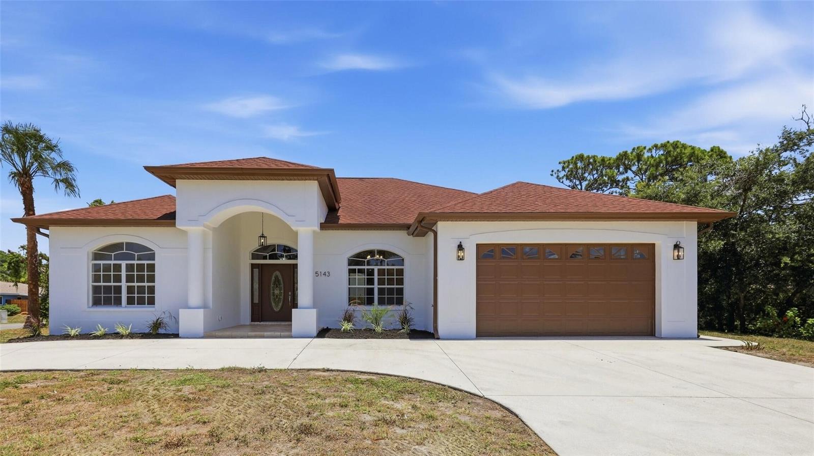 WOW - this is the one you've been waiting for! Nearly 2,300 sq ft of stunning South Venice living on an oversized TRIPLE LOT (12,000 sq ft!), and it shows like a model home. From the moment you arrive, the circular driveway and lush palms set the tone. Step through the decorative glass entry into soaring volume ceilings, dramatic tray-ceiling architecture, rich hardwood floors, and an open layout flooded with natural light. The chef's kitchen steals the show with gleaming QUARTZ countertops, a marble-look backsplash, brand-new stainless appliances, and an oversized peninsula made for gathering. Retreat to spacious bedrooms, a flexible office/den (perfect 4th bedroom!), and two beautifully appointed baths featuring double vanities, sleek backlit mirrors, and a relaxing garden tub. Out back, a screened lanai overlooks your fully fenced, park-like yard - room for a pool, a boat, an RV, and all your toys thanks to the rare rear driveway. 2-car garage, inside laundry, and custom built-ins throughout. Flood Zone X (NO flood insurance!), NO HOA, NO CDD, and optional private beach ferry + boat ramp access. Minutes to Gulf beaches, Shamrock Park, shopping & US-41. Space, style, and location like this won't last !