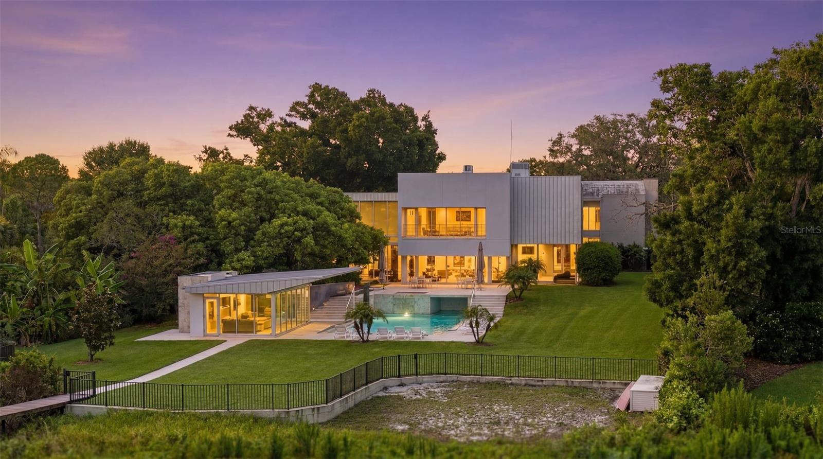 Prepare to be amazed — this massive, gorgeous White Trout Lake estate is unlike anything else on the market, and located just 15 minutes from downtown Tampa. From the moment you arrive, incredible architectural detail sets the tone for a home that was designed to impress at every turn. Inside, the 5 oversized bedrooms are joined by a jaw-dropping lineup of bonus spaces you won’t find anywhere else: a dedicated GOLF room, a full EXERCISE room, a MOVIE room, a GAME room loft plus and extra BONUS room! There is even a dedicated outdoor area for PICKLEBALL! Whatever your passion, this home has a room built just for it. With 6 full bathrooms and 2 half baths - there’s effortless comfort for family and guests alike. Head outside and step into your own private RESORT. A stunning POOL and SPA are complemented by an incredible air-conditioned CABANA with a FULL KITCHEN and plenty of room to enjoy a lovely meal poolside. The thrilling SLIDE makes this backyard a nonstop hit with the kids and a full BATHROOM adds convenience for everyone. The expansive BACKYARD is fully FENCED which adds peace of mind to the non-stop fun. For boaters, the private dock, boat lift, and jet ski dockage put the water at your fingertips. Enjoy water skiing, tubing, fishing and other water sports at any time on this private 78 acre SKI LAKE. Want more? There are multiple garages that can accommodate a serious car collection plus air-conditioned storage and a large shed for everything else. A home generator means the fun never has to stop, no matter the weather. This isn’t just a home — it’s a lifestyle, and it’s one you have to see to believe. Estates like this simply don’t come along twice. Schedule your private tour today!