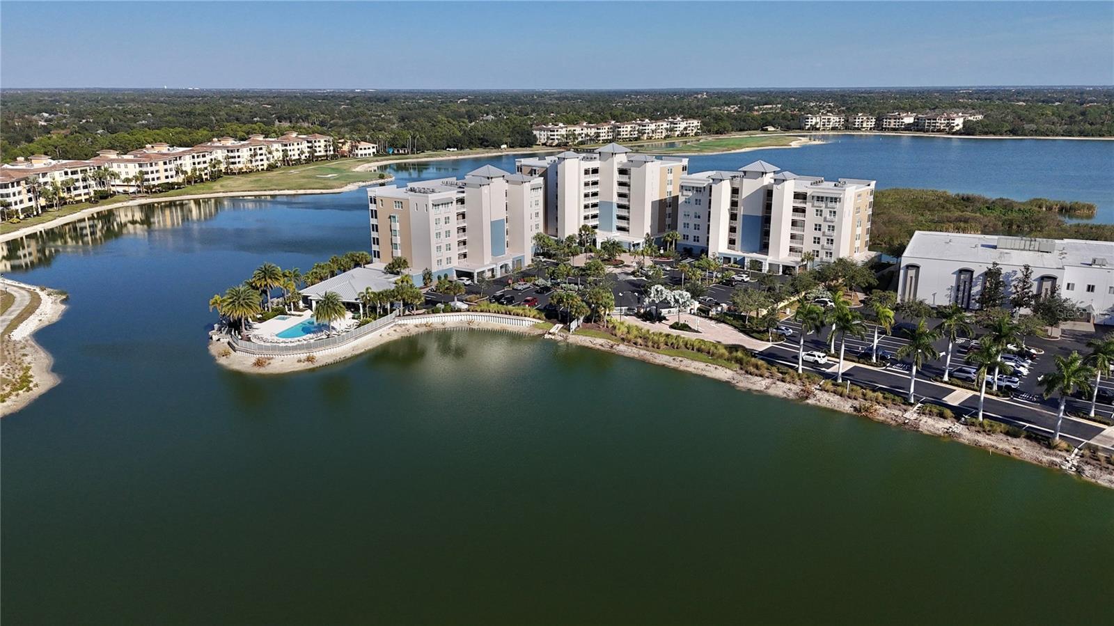 Price Reduced! Motivated seller. Amazing 3 bedroom condo with beautiful water view located in the desirable Waterfront on Main community. Experience relaxed waterfront living in the center of Lakewood Ranch, one of the nation’s most recognized master-planned communities, with the added benefit of being within walking distance to the famous Main Street at Lakewood Ranch for dining, movie theatre, shopping, farmers market. This well cared for 3-bedroom, 2-bath end-unit condo offers the sought after Cayman floor plan, designed with an open layout that connects the kitchen and dining area to the living space and extends outdoors to the spacious lanai, perfect for daily living and hosting guests. Interior features include coffered ceilings, solid wood cabinets, granite countertops, a custom-shelved pantry, and a custom built-in shelve for walk-in closet. Both the spacious living area and the primary bedroom open to a large lanai overlooking a serene 153-acre lake, where you can enjoy tranquil views and year round wildlife. All three bedrooms are finished with newer carpet for a fresh and comfortable feel.

The gated community provides assigned garage parking along with a private storage locker conveniently located under the building. Residents have access to impressive resort style amenities, including a heated pool set along the lake, spa, fire pit, grilling areas, a fully equipped fitness center, and scenic walking paths along the water. The clubhouse offers a catering kitchen, generous outdoor gathering spaces, kayak storage, and direct access to the lake. Ideally situated just minutes from Legacy Golf Course and within walking distance to Lakewood Ranch Main Street, you will enjoy easy access to dining, shopping, movies, miniature golf, and year round events. Additional highlights include impact resistant windows and sliding doors, as well as a built-in ceiling sprinkler system for added fire safety. The central location offers quick access to UTC Mall, downtown Sarasota and Bradenton, I-75, and nearby beaches such as Lido Key and Anna Maria Island.