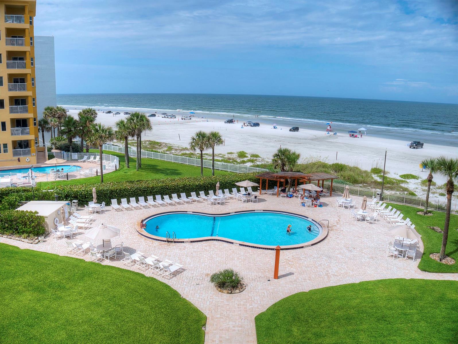 Imagine yourself in paradise, imagine yourself here at the Golden Arms.  This incredible 2/2 condo directly on the glimmering sands of New Smyrna Beach sits on a point, so it offers picturesque views of the ocean from the nearly every room. The spacious living area and the huge master bedroom both feature incredible views of the ocean as well as access to the balcony where you can bask in spectacular sunrises and warm summer breezes.  Whether you are looking for your new permanent home, a place to get away or are looking to invest, this beautiful condo is ideal.  The kitchen offers an easy to work in floor plan which overlooks the living area and YUP, more views of the ocean over a breakfast bar that seats 3-4 comfortably.   Amenities of the association include the pool, shuffleboard courts and a one car garage for the unit.  Pest control and building insurance are also included.  All located less than one mile from the dining, shopping, and entertainment of exciting Flagler Avenue.  Come for the fun, stay for the relaxation. Come home to the BEACH! ;LocationDescription: Condo ;Water: City