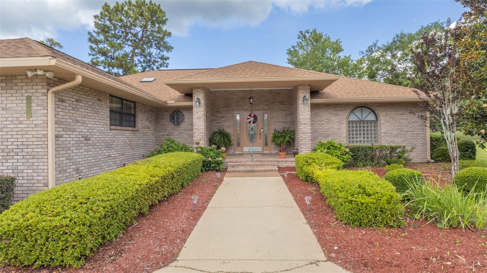 Welcome home where comfort, space, and convenience come together in this beautifully maintained brick home. Designed with both everyday living and entertaining in mind, this home features two spacious primary suites, offering exceptional flexibility for multi-generational living, guests, or added privacy. The large, open-concept living area creates a warm and inviting gathering space that flows seamlessly into an expansive sunroom, filling the home with natural light. Step outside to the generous patio, perfect for dining, relaxing, or hosting family and friends. The well-appointed kitchen is complemented by an oversized pantry, providing abundant storage for all your culinary needs. Car enthusiasts and hobbyists will appreciate the attached two-car garage with a separate golf cart space, offering extra room for recreational vehicles, storage, or a workshop. Located just minutes from downtown Keystone Heights, enjoy convenient access to local shops, restaurants, schools and lakes.