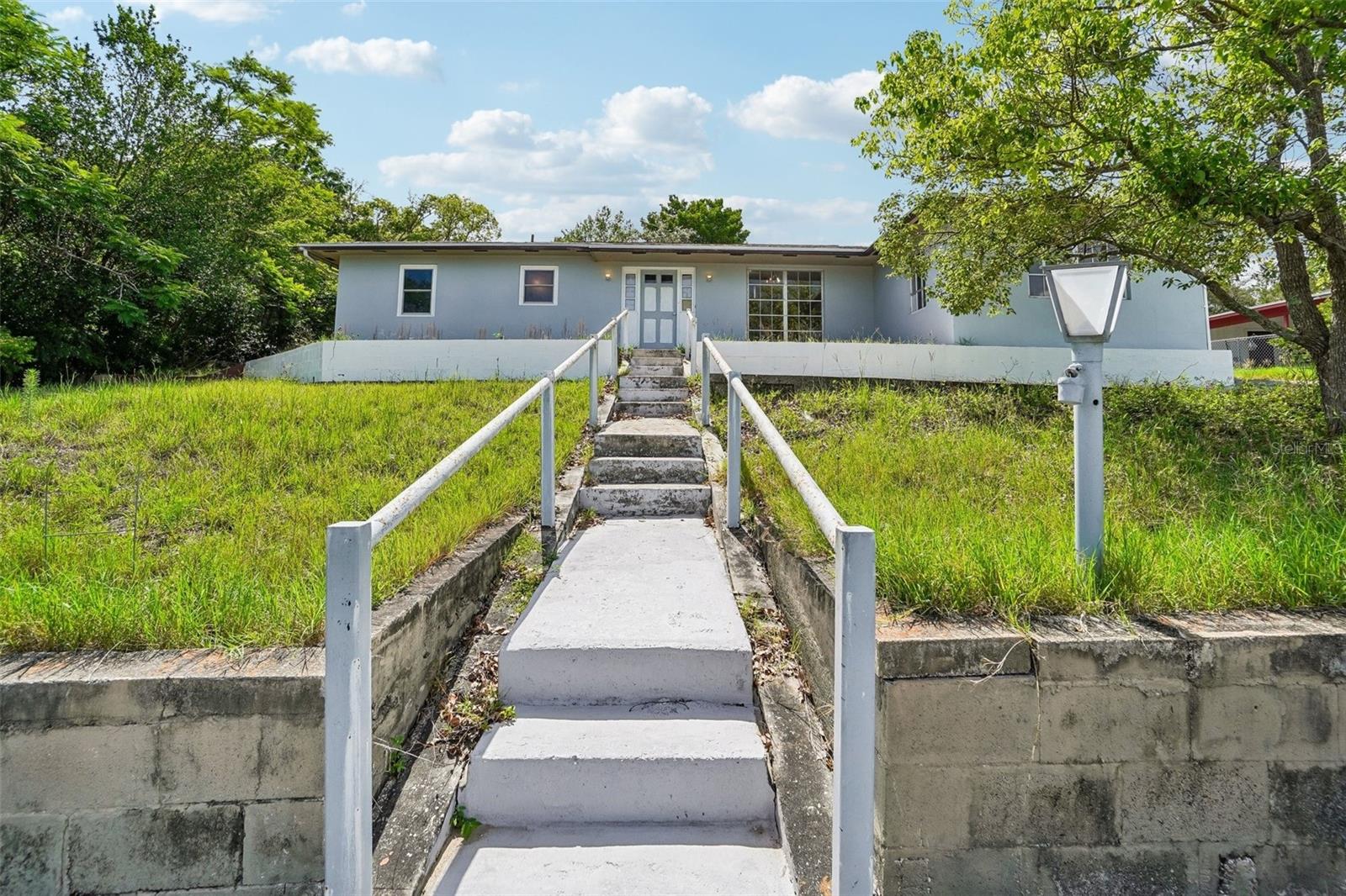 INVESTOR SPECIAL WITH TONS OF POTENTIAL IN THE HEART OF SPRING HILL! This spacious 5 bedroom, 2 bathroom home offers approximately 1,836 square feet of living space and is ready for someone to bring it back to life. Originally built as a 2 bedroom, 2 bath home, the property was later expanded with additional bedrooms, including a garage conversion, creating plenty of possibilities for a large household, rental property, or future flip opportunity. Renovations have already been started but remain unfinished, giving the next owner the opportunity to complete the project to their own taste and vision. Several windows have already been replaced, and portions of the home have been painted and updated. Situated high on a hill, the home features a large driveway, carport parking, and a screened enclosure surrounding an in-ground pool. The pool itself is larger and deeper than most newer pools, offering the potential to create an impressive outdoor entertaining space once updated. This property is being sold as-is, making it best suited for investors or cash buyers looking for a true fixer-upper with upside potential. With the flexible floorplan, large pool area, and convenient central Spring Hill location close to shopping, restaurants, parks, schools, and major roadways, this property could become something truly special with the right vision and improvements. Bring your ideas and unlock the potential of this diamond in the rough!