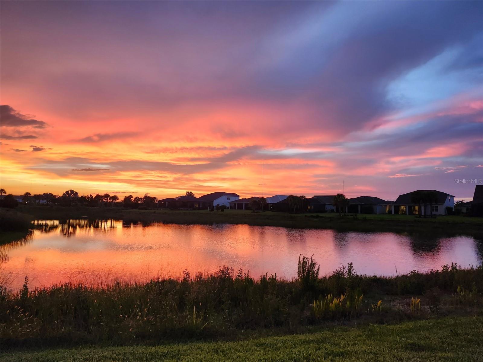 Experience the best of Florida living in this beautifully designed west-facing pool home, perfectly positioned on a peaceful waterfront lot in the desirable Parkside neighborhood of Babcock Ranch. Offering spectacular sunset views, a private pool and spa, and an ideal location just a short stroll to Founder’s Square through scenic Telegraph Park, this home combines luxury, comfort, and convenience. Designed with both everyday living and entertaining in mind, the spacious floor plan features four bedrooms, a dedicated den, 2.5 bathrooms, and an upstairs loft that easily adapts as a media room, playroom, or additional living space. The open-concept main level is centered around a stunning kitchen complete with a massive quartz island, gas range, oversized walk-in pantry, and convenient drop zone. Step outside to your own backyard retreat where the sparkling pool, attached spa, and sail shades create the perfect setting for relaxing while overlooking tranquil lake views and unforgettable Southwest Florida sunsets. Upstairs, the private owner’s suite is thoughtfully positioned at the rear of the home to maximize the water views. This spacious retreat offers a cozy sitting area, an oversized walk-in closet, and a luxurious ensuite bath with a soaking tub designed for relaxation. Three additional bedrooms, a full bath, loft, and an upstairs laundry room with GE Profile high-efficiency washer and dryer provide exceptional functionality for family and guests. Additional features include abundant storage throughout the home and overhead storage in the attached two-car garage. Located in America’s first solar-powered town, Babcock Ranch offers an unmatched lifestyle with miles of walking and biking trails, parks, lakes, restaurants, shopping, and year-round community events including Food Truck Fridays, live entertainment, and the popular Sunday Farmers Market—all just minutes from your front door. If you’ve been searching for a spacious pool home with breathtaking sunsets, waterfront views, and an incredible location, this is the one you’ve been waiting for.
