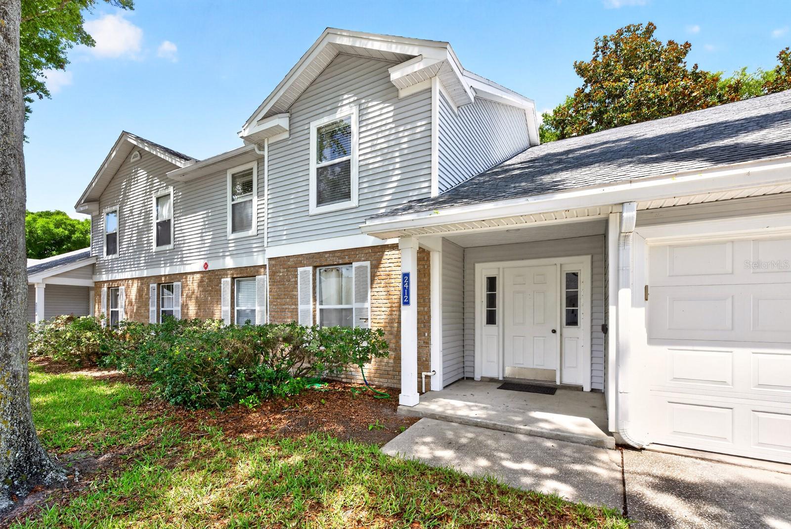 Welcome to this BEAUTIFULLY MAINTAINED first-floor condo in the sought-after Coach Homes at Mariners Village near Conway, where stylish upgrades, effortless comfort, and a PRIME ORLANDO LOCATION come together beautifully. Offering 2 bedrooms, 2 baths, and a private 1-car garage with EPOXY FLOORING, this inviting home is tucked inside a QUIET, WELL-KEPT COMMUNITY and delivers the perfect blend of charm and low-maintenance living. Step inside and immediately appreciate the bright open-concept layout, where the Living Room, Dining area, and Kitchen flow seamlessly together beneath an abundance of NATURAL LIGHT. Updated WOOD-LOOK TILE FLOORING throughout the home creates a warm, modern feel while adding durability and easy upkeep. The spacious Living Room is FILLED WITH SUNLIGHT and features sliding glass doors that open to the COVERED and ENCLOSED SCREENED PATIO, creating the perfect indoor-outdoor retreat for relaxing mornings or peaceful evenings. The Dining area also offers sliding doors to the patio and is accented by a CUSTOM BUILT-IN WALL FEATURE complete with cabinetry, shelving, and a stylish bar area, making entertaining both easy and elegant. At the heart of the home, the stunning UPDATED Kitchen truly shines with crisp white cabinetry, marble-look countertops, stainless steel appliances, a WALK-IN PANTRY CLOSET, and a center island with breakfast bar seating—a space that feels equally functional and designer-inspired. As you make your way through the hallway to the Bedrooms, you'll notice how its enhanced with CLASSIC WAINSCOTING, adding a refined touch of architectural detail. The GENEROUS PRIMARY SUITE offers a relaxing private retreat, complete with a walk-in closet and beautifully UPDATED EN SUITE BATH featuring a modern vanity and sleek step-in shower. A second spacious bedroom and nearby full bath provide flexibility for guests, family, or a home office. Additional MAJOR UPDATES include a NEW ROOF (2022), NEW AC (2022), and WATER HEATER (2017), adding peace of mind and true MOVE-IN READY convenience. Residents of Coach Homes at Mariners Village enjoy FANTASTIC AMENITIES including a clubhouse, sparkling community pool, and beautifully maintained grounds, while the HOA covers cable, internet, water, trash, exterior maintenance, grounds maintenance, and pool care—allowing you to enjoy a CAREFREE LIFESTYLE. Perfectly located near the highly desirable Conway district, you’ll enjoy EASY ACCESS to shopping, dining, and outdoor recreation around Lake Conway. Downtown Orlando, Lake Eola Park, the Dr. Phillips Center for the Performing Arts, and Orlando International Airport are all JUST MINUTES AWAY, along with quick access to major highways and Central Florida’s WORLD-FAMOUS ATTRACTIONS. With its designer-inspired updates, bright open layout, screened patio, and unbeatable location, this Coach Homes at Mariners Village condo offers an EXCITING OPPORTUNITY to enjoy easy, stylish Florida living at its best. Make this home yours before its gone!