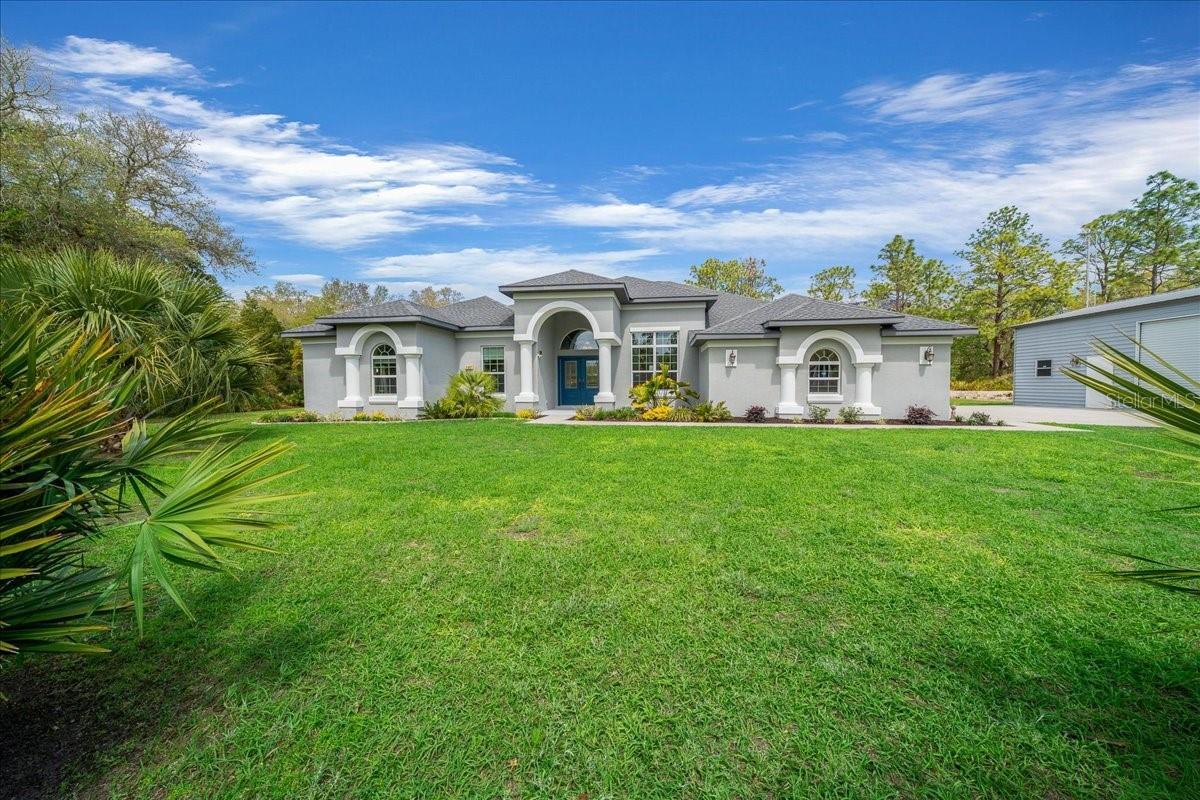 2022 Custom Pool Home on 1.16 acres with 22x30 Powered Workshop- NO HOA! Experience refined, modern living in this exceptional home located in sought-after Citrus County Florida. Built by Sweetwater Homes, the home is 300 amp with 100 amp service dedicated to the detached garage. Sellers paid meticulous attention to detail throughout the construction process, resulting in a home that seamlessly blends quality craftsmanship with contemporary design.  The open-concept floor plan showcases clean lines, abundant natural light, and a layout designed for both elevated everyday living and effortless entertaining. Step outside to your screened-in pool with spa, offering a serene outdoor retreat for enjoying year-round sunshine. The 22x30 detached garage with workbench and built in shelving provides flexibility for storage, hobbies, or a large workshop. Positioned on an oversized corner lot, this property features 4 bedrooms and 2 beautifully appointed bathrooms. Ideally located near premier fishing, scenic bike trails, and just a short drive from the expanding Suncoast Parkway, this home delivers a rare combination of modern style, functionality, and convenience. A truly distinctive property for those seeking upscale living with thoughtful design and attention to detail.
