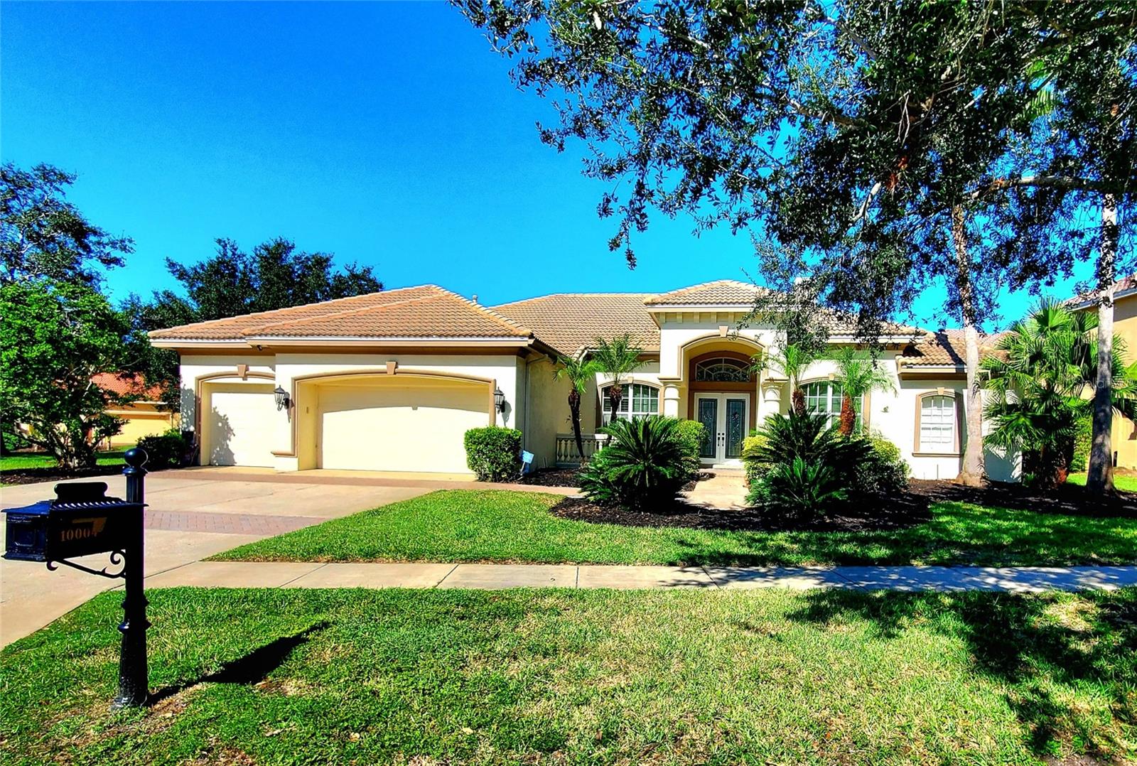 **WESTCHASE GATED COMMUNITY!** Just minutes from Westchase Towne Center for all your shopping and entertainment needs, Tree Top Lakes offers the perfect mix of luxury and peace. This private neighborhood of beautiful homes surrounds the 25-acre spring-fed Tree Top Lake. One of the most affordable lakefront properties here, this home boasts over 3,500 square feet of living space plus a massive (57 x 48) screened outdoor area with a pool. The spacious pool deck includes an outdoor kitchen with a natural-gas grill and dining area—perfect for entertaining. Beyond the pool, the large backyard is great for pets and play, with the lake offering fishing and gorgeous sunset views. Built for a growing family, the home features 4–5 bedrooms including a master suite, 3 guest rooms, a home office, and a newly renovated bonus room with fresh paint and new flooring. The living room opens to the pool via French doors and has a gas fireplace, while the family room offers high ceilings and built-ins. Designer touches include crown molding and cherrywood floors throughout. The kitchen has a dinette space, a bar with wine fridge, and plenty of room. There are 3 spacious secondary bedrooms, 2 guest baths (one a pool bath), plus a laundry room leading to the 3-car garage. Extras include a tankless water heater, smart home features, a security system, and whole home water filtration. The community offers a playground, basketball court, and waterfront park with dock and gazebo, all close to Westchase Golf Course with easy access to Pinellas beaches and downtown Tampa.